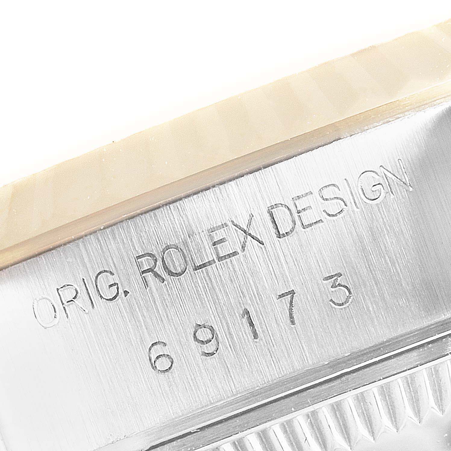 This image shows a close-up of the model number and inscription on the side of a Rolex Datejust 69173 Women's Steel and Gold (two tone) White Dial 69173 Women's Steel and Gold (two tone) White Dial watch case.