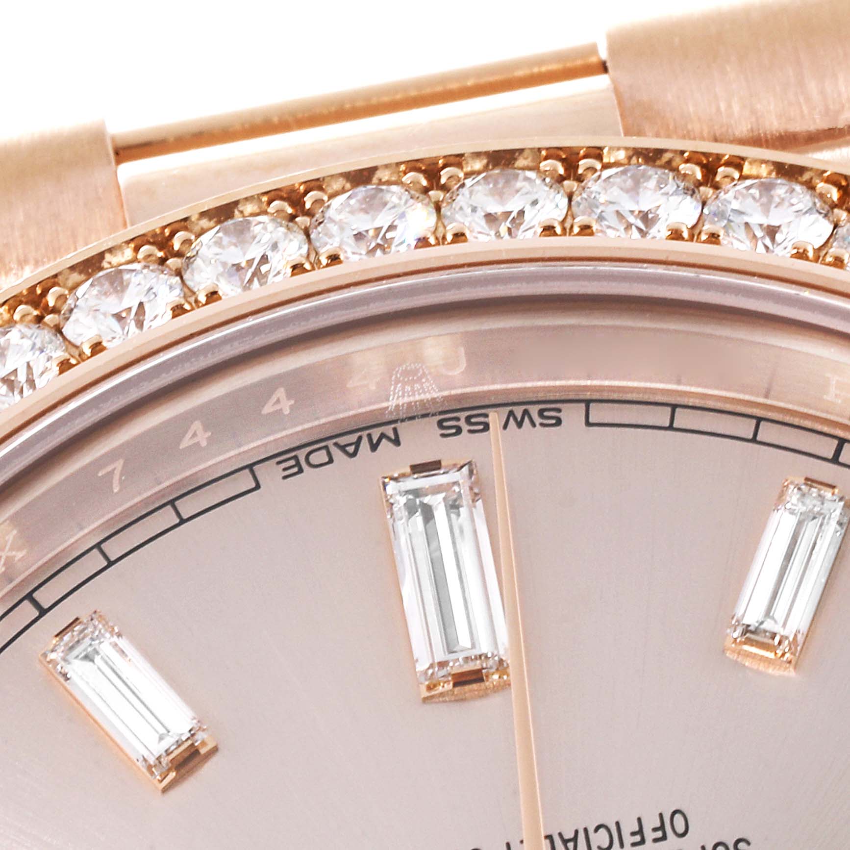 Close-up of a Rolex President 228345RBR Men's Rose Gold Pink Dial 228345RBR Men's Rose Gold Pink Dial model showing part of the dial and diamond-encrusted bezel.
