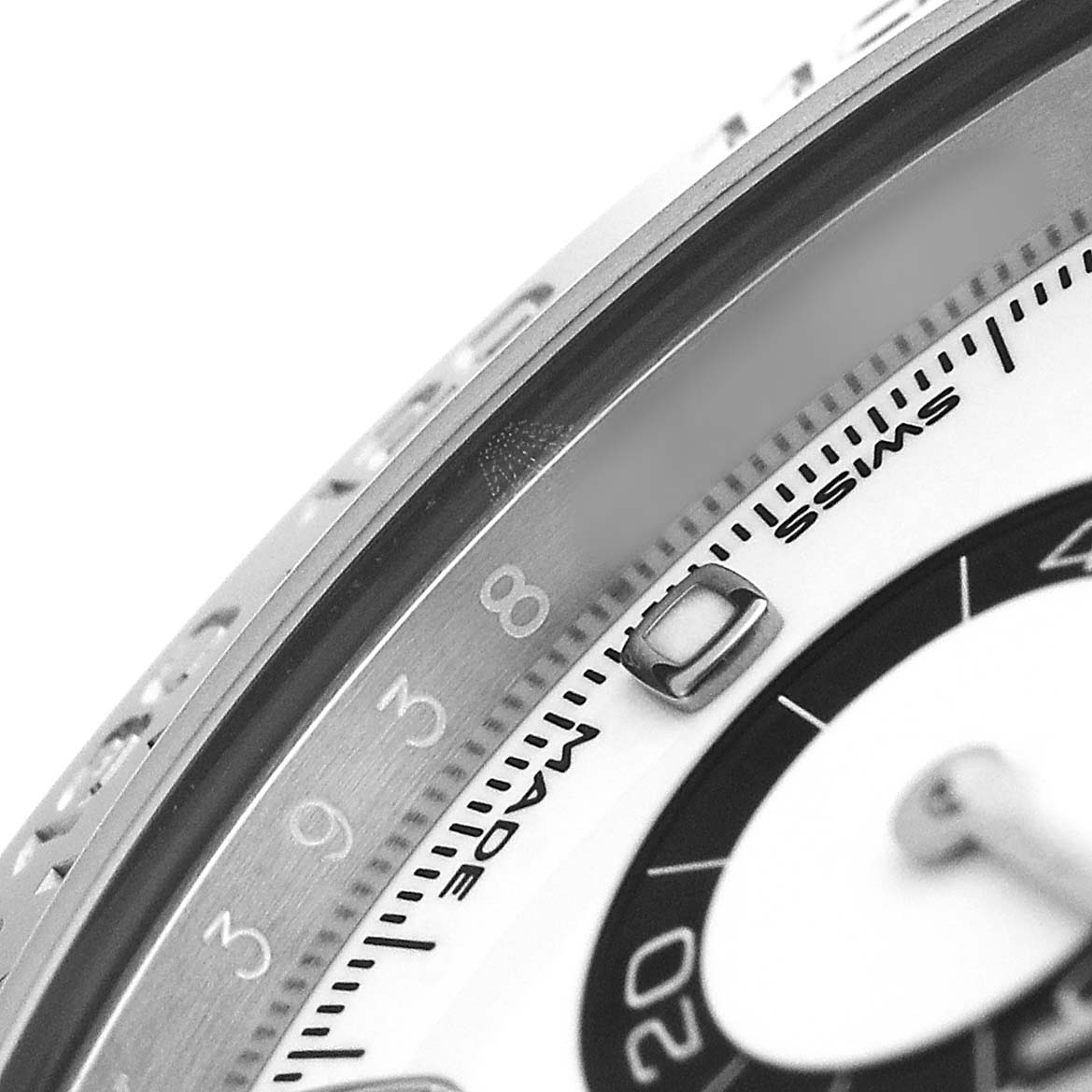 The image shows a close-up of the Rolex Daytona 116500LN Men's Stainless Steel White Dial watch, focusing on the bezel and part of the dial.