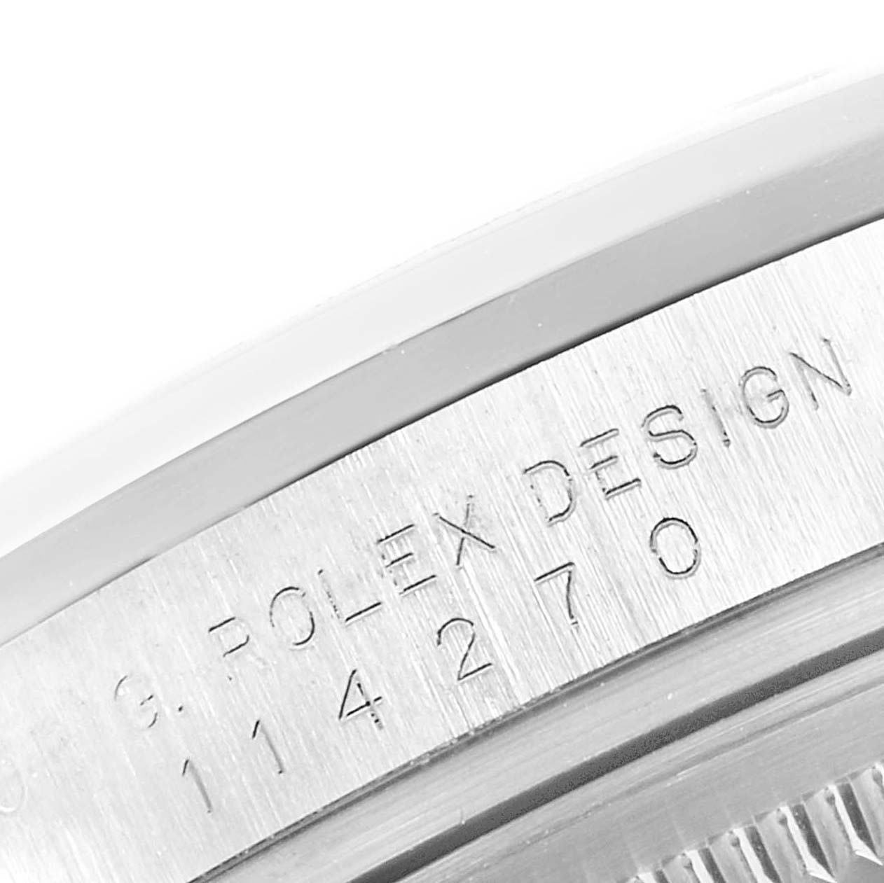 This close-up image shows the engraved bezel and part of the case back of a Rolex Explorer 114270 Men's Stainless Steel Black Dial 114270 Men's Stainless Steel Black Dial watch.