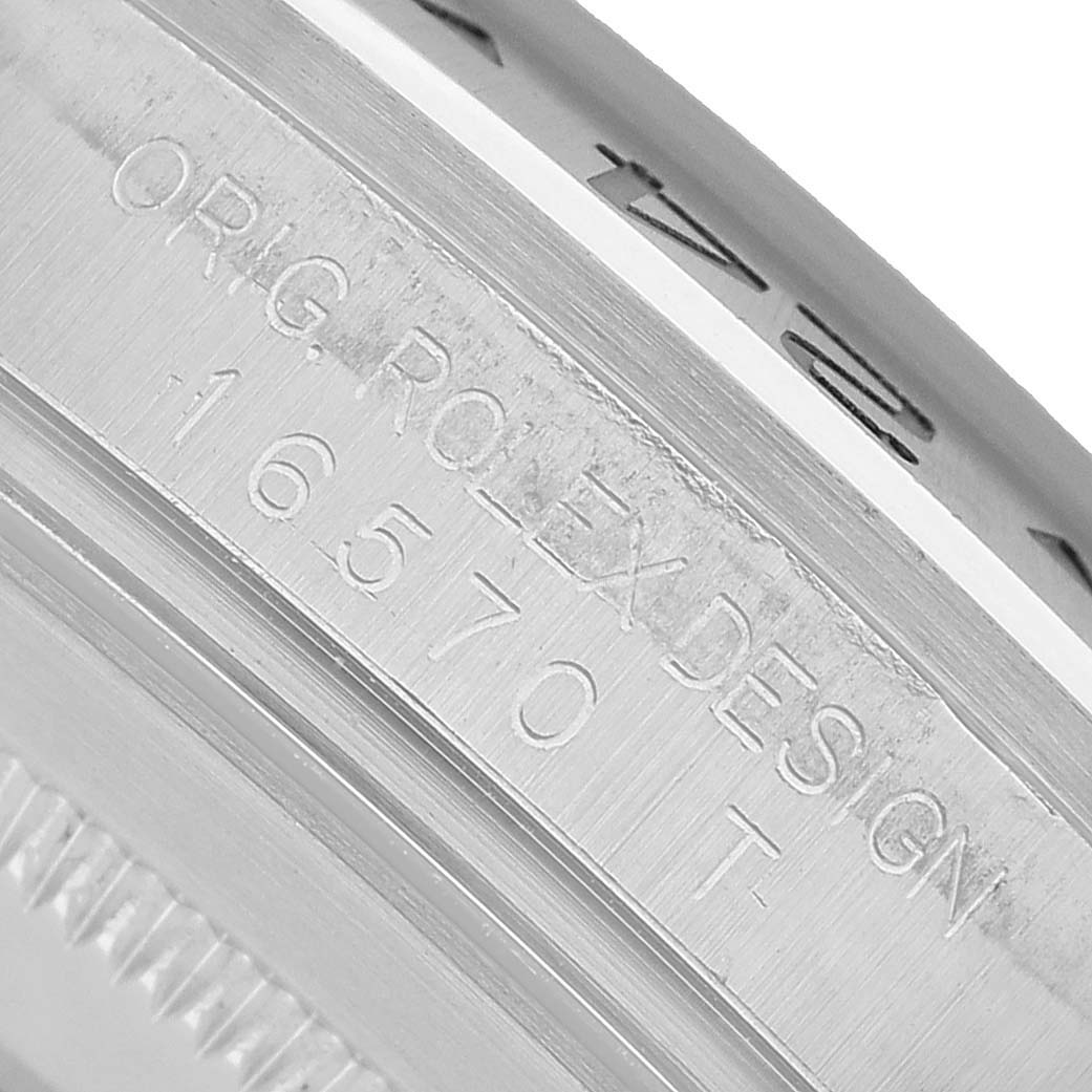 The image shows a close-up of the Rolex Explorer 16570 T Men's Stainless Steel Black Dial's engraved case side at an angle.