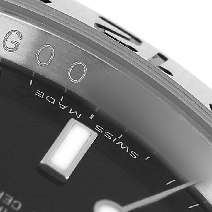 The image shows a close-up of the bezel and part of the dial of a Rolex Explorer 16570 T Men's Stainless Steel Black Dial watch.