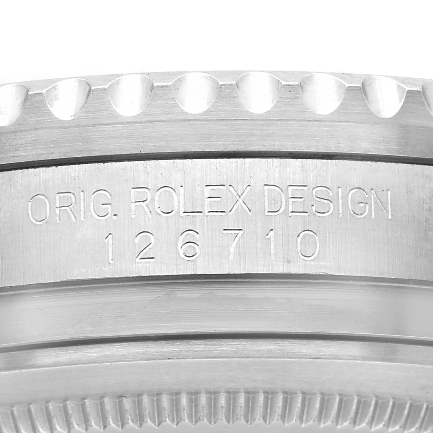 The image shows the side engraving of a Rolex GMT-Master 126710 Men
s Stainless Steel Black Dial 126710 Men
s Stainless Steel Black Dial, focusing on the model number and original design text.