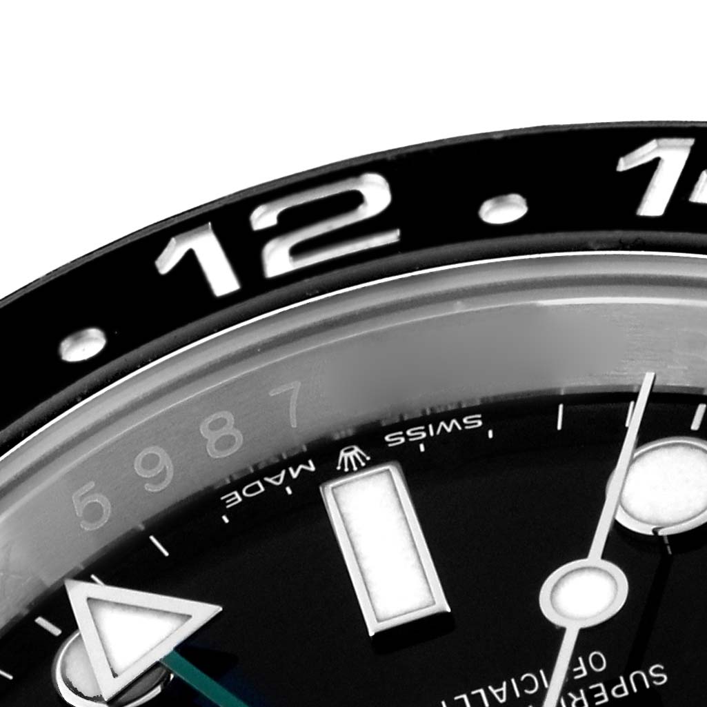 The image shows a close-up of the dial and bezel of the Rolex GMT-Master 126710 Men
s Stainless Steel Black Dial 126710 Men
s Stainless Steel Black Dial, focusing on the 12-hour marker and Swiss Made label.