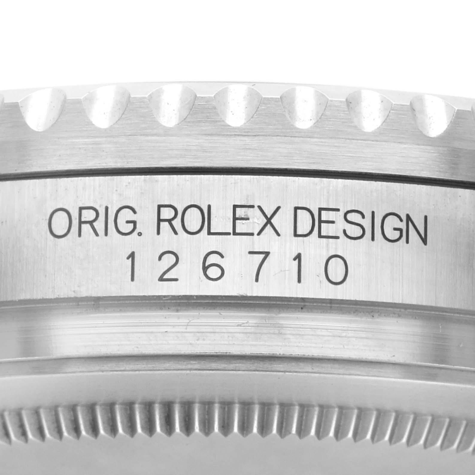 The image shows the side view of a Rolex GMT-Master 126710 Men
s Stainless Steel Black Dial 126710 Men
s Stainless Steel Black Dial model, focusing on the engraved bezel.