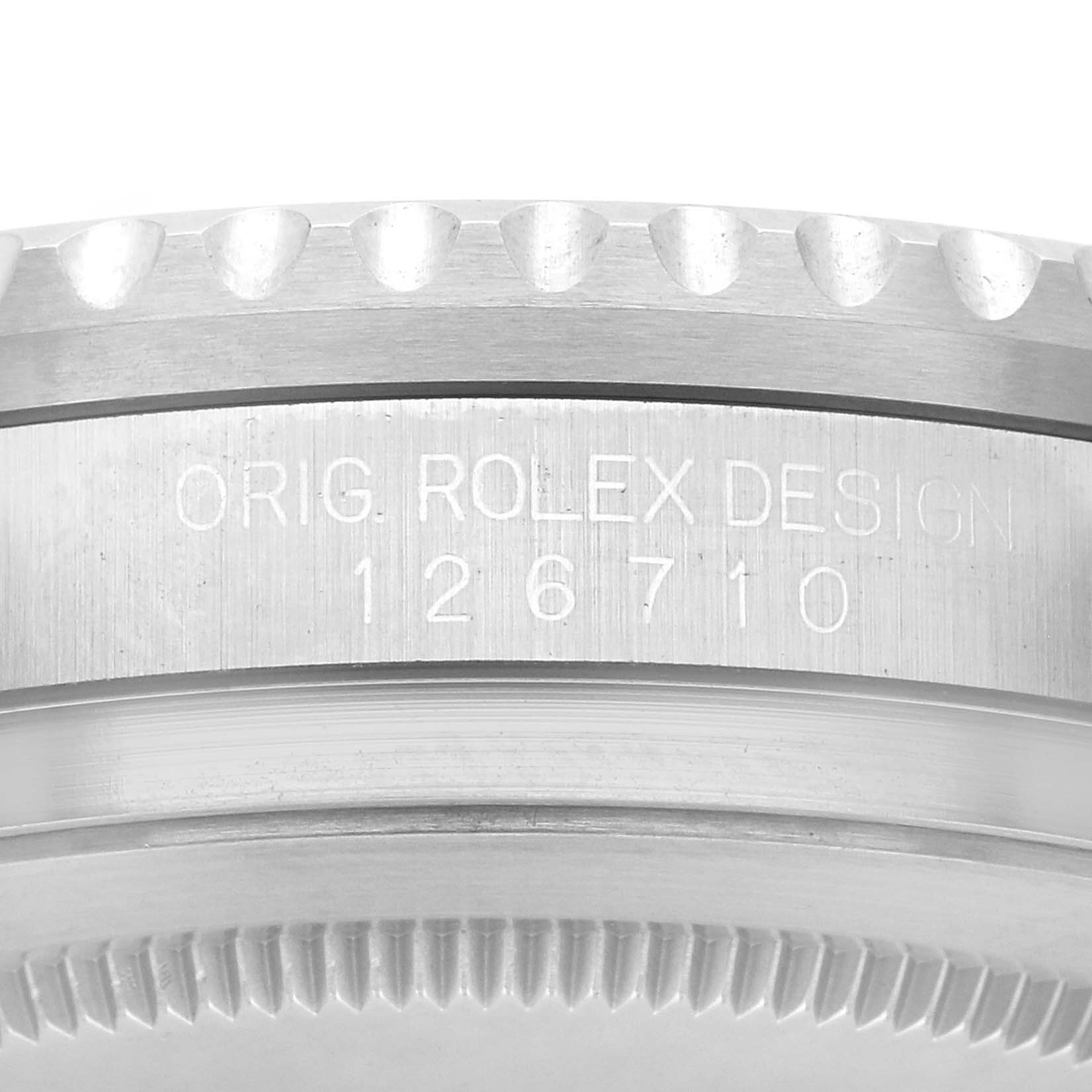 This image shows the side of a Rolex GMT-Master 126710 Men
s Stainless Steel Black Dial 126710 Men
s Stainless Steel Black Dial, highlighting the engraved model number and part of the bezel.