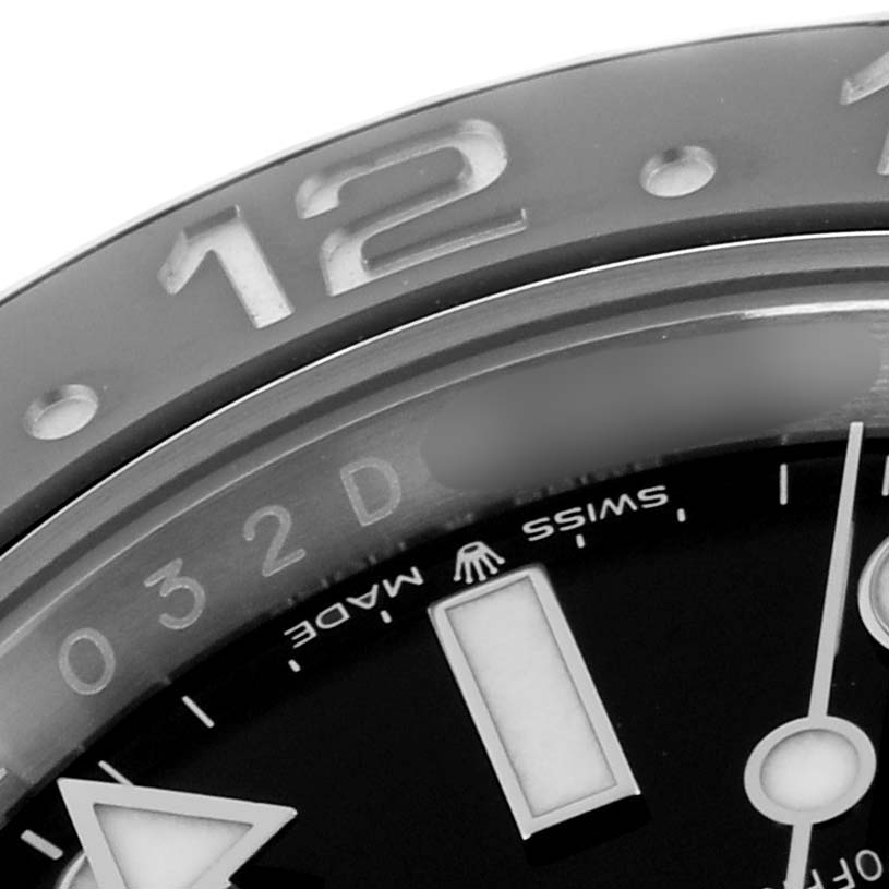 The image shows a close-up of the bezel and part of the dial of a Rolex GMT-Master 126710 Men
s Stainless Steel Black Dial 126710 Men
s Stainless Steel Black Dial, highlighting the 12 o
clock marker.