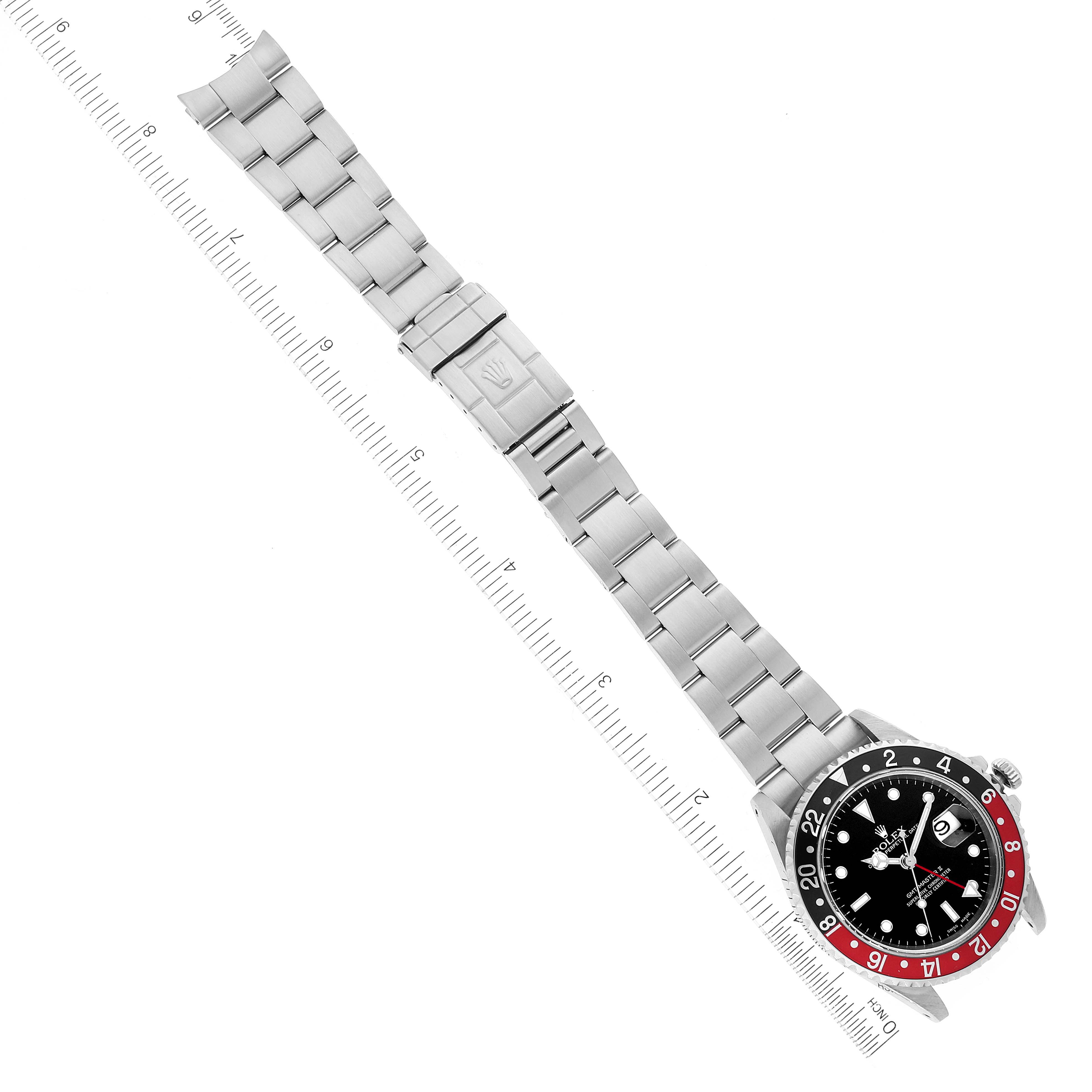 The image shows a top-down view of a Rolex GMT-Master 16710 Men
s Stainless Steel Black Dial 16710 Men
s Stainless Steel Black Dial watch with a stainless steel bracelet.