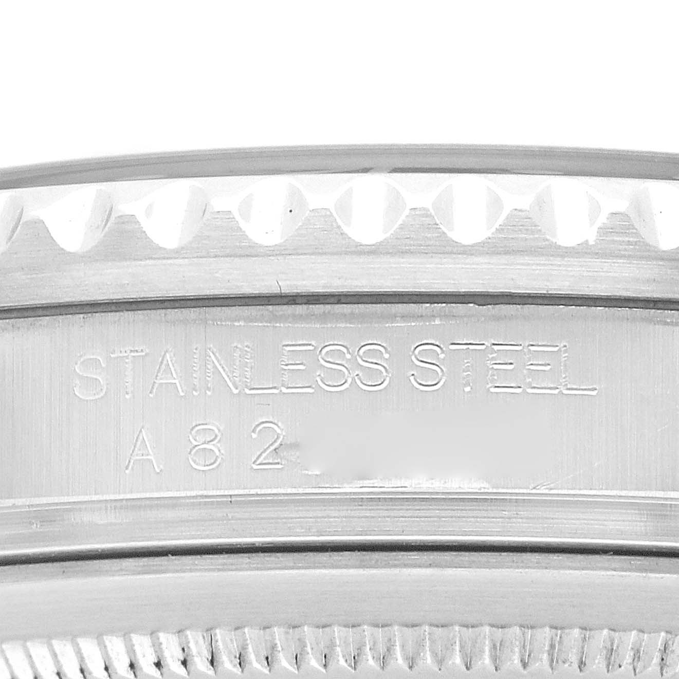 The image shows a close-up of the Rolex GMT-Master 16710 Men
s Stainless Steel Black Dial 16710 Men
s Stainless Steel Black Dial
s case edge with engraved markings.