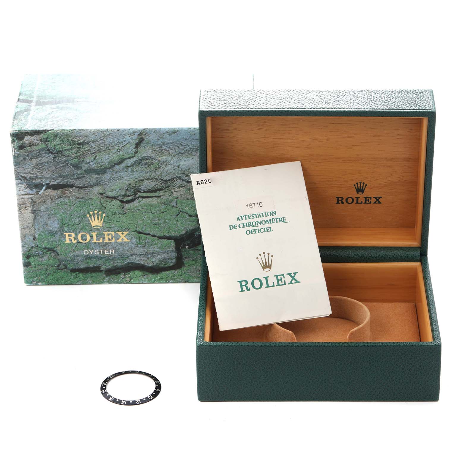 The image shows a Rolex GMT-Master 16710 Men
s Stainless Steel Black Dial 16710 Men
s Stainless Steel Black Dial watch box with paperwork and a separate bezel insert, displayed from a front angle.