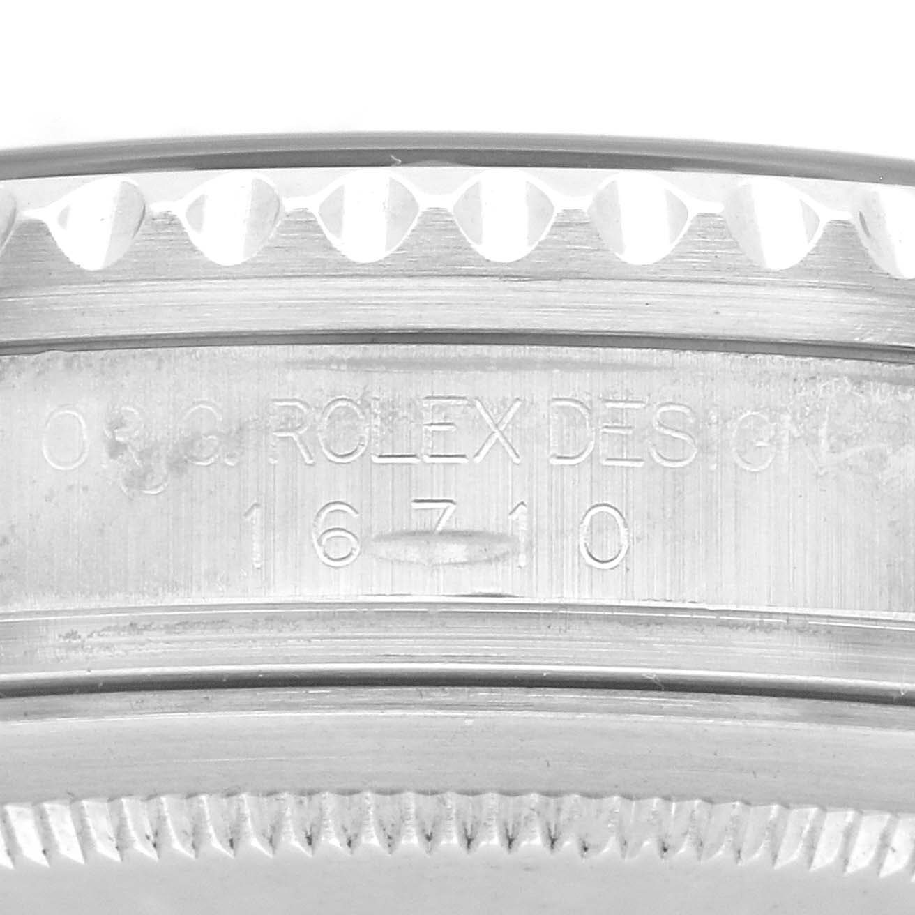 The image shows the side of a Rolex GMT-Master 16710 Men
s Stainless Steel Black Dial 16710 Men
s Stainless Steel Black Dial, focusing on the engraved bezel and model reference number.