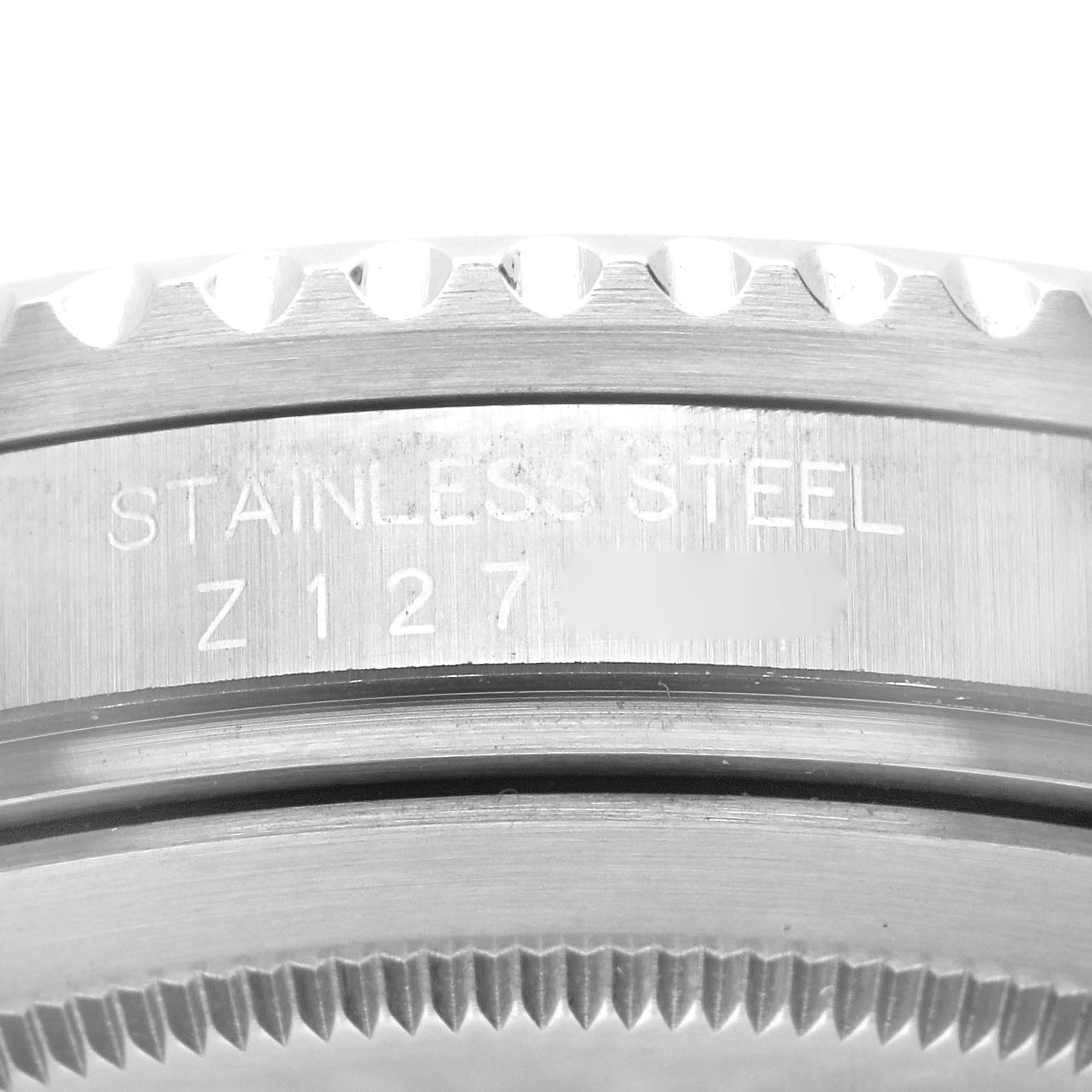 Close-up of the case back edge of a Rolex GMT-Master 16710 Men's Stainless Steel Black Dial 16710 Men's Stainless Steel Black Dial watch, showing the stainless steel material and part of the bezel teeth.