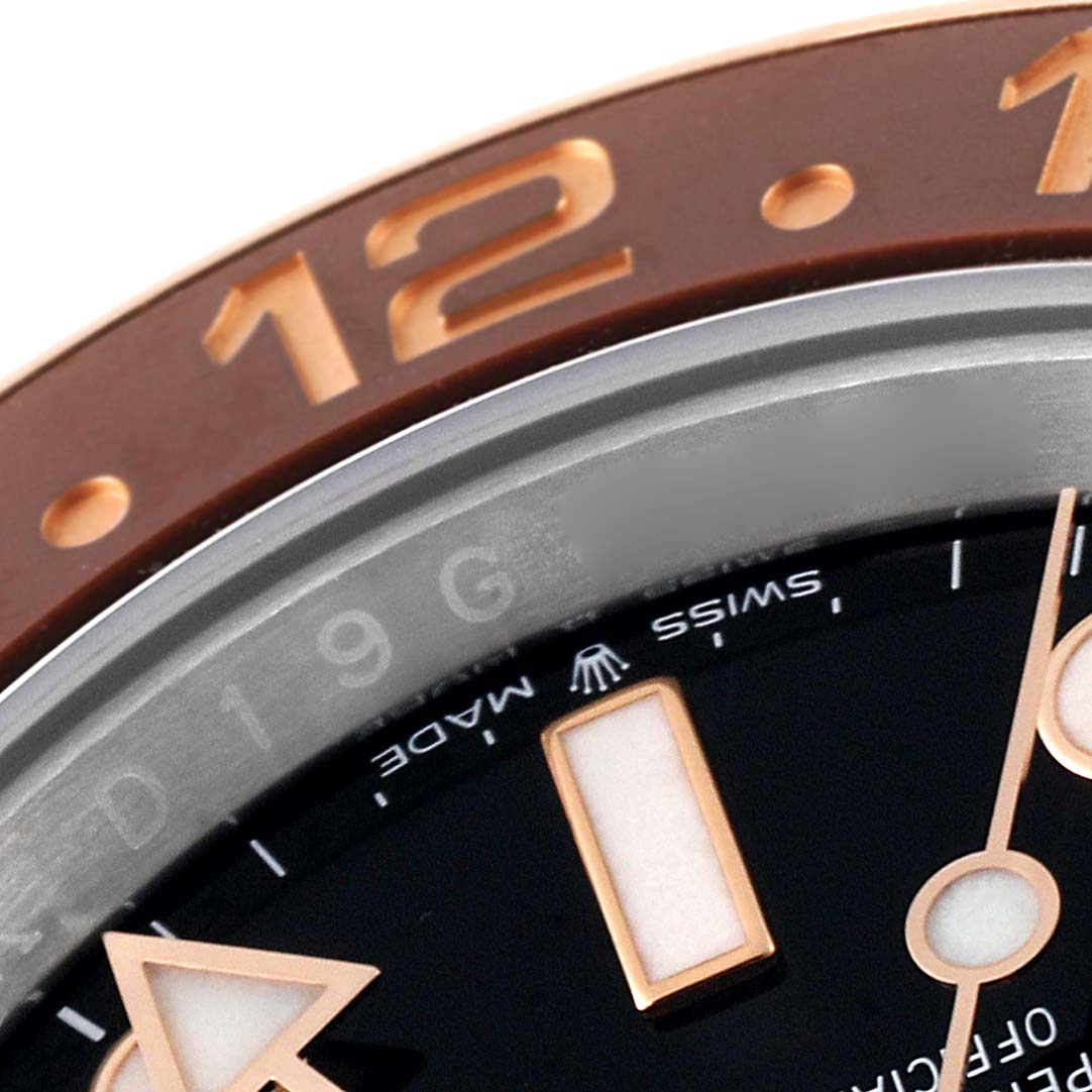 This close-up image shows the bezel and part of the dial of the Rolex GMT-Master 126711 Men's Steel and Gold (two tone) Black Dial 126711 Men's Steel and Gold (two tone) Black Dial watch.