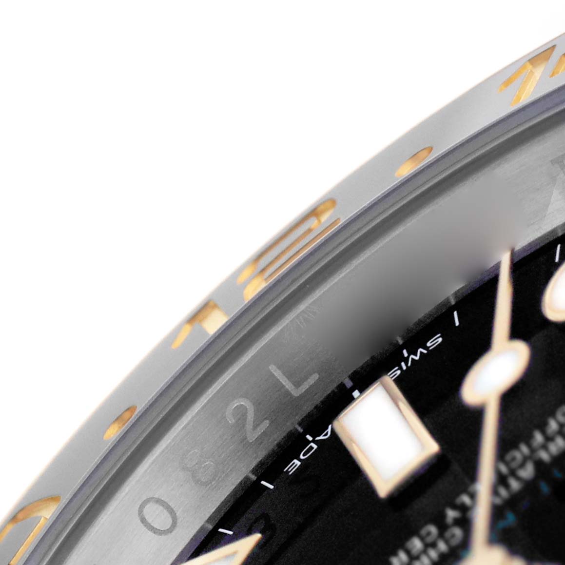 The image shows a close-up of the bezel and part of the dial on a Rolex GMT-Master M116713LN Men's Steel and Gold (two tone) Black Dial watch.