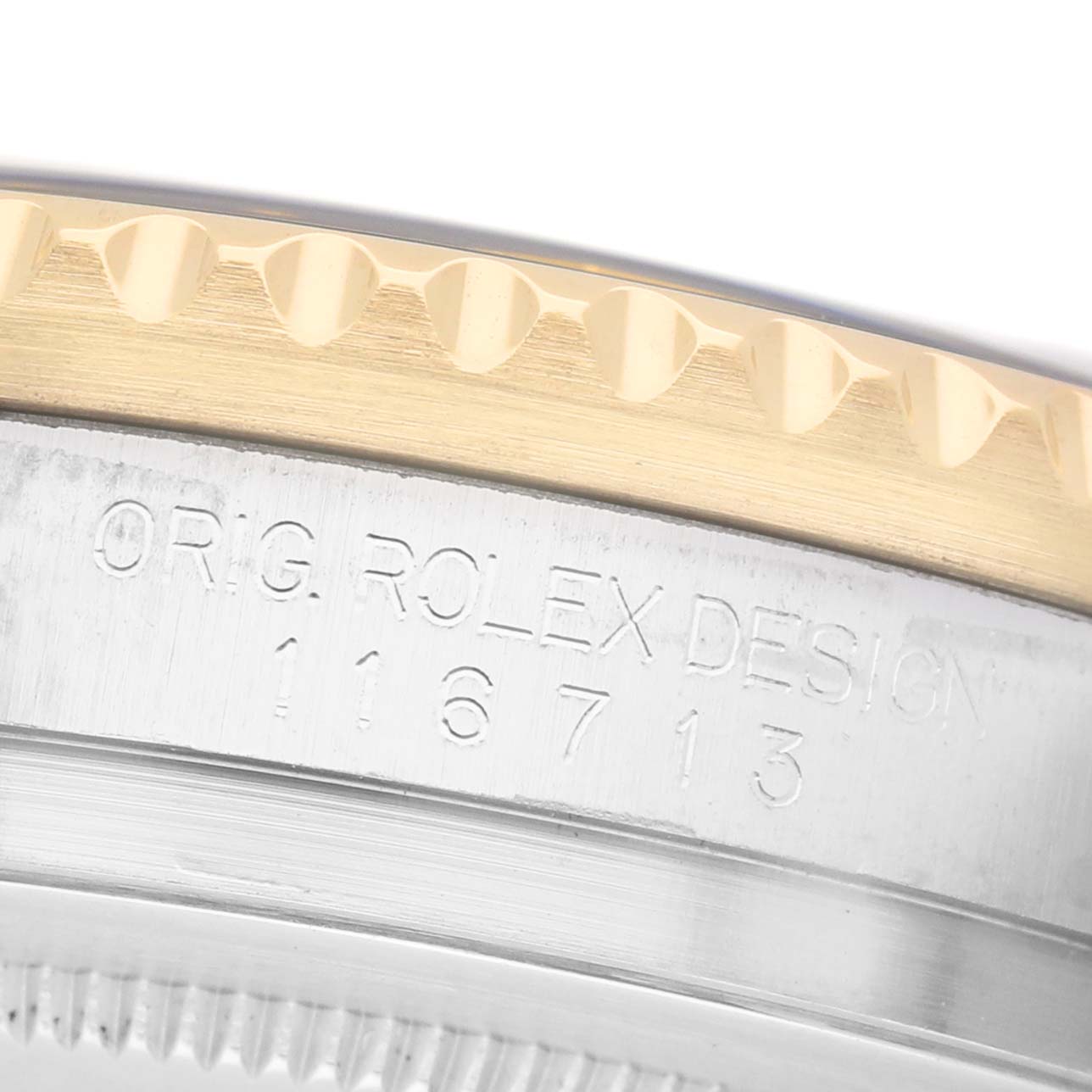 The image shows a close-up of the side engravings and bezel of a Rolex GMT-Master M116713LN Men's Steel and Gold (two tone) Black Dial.