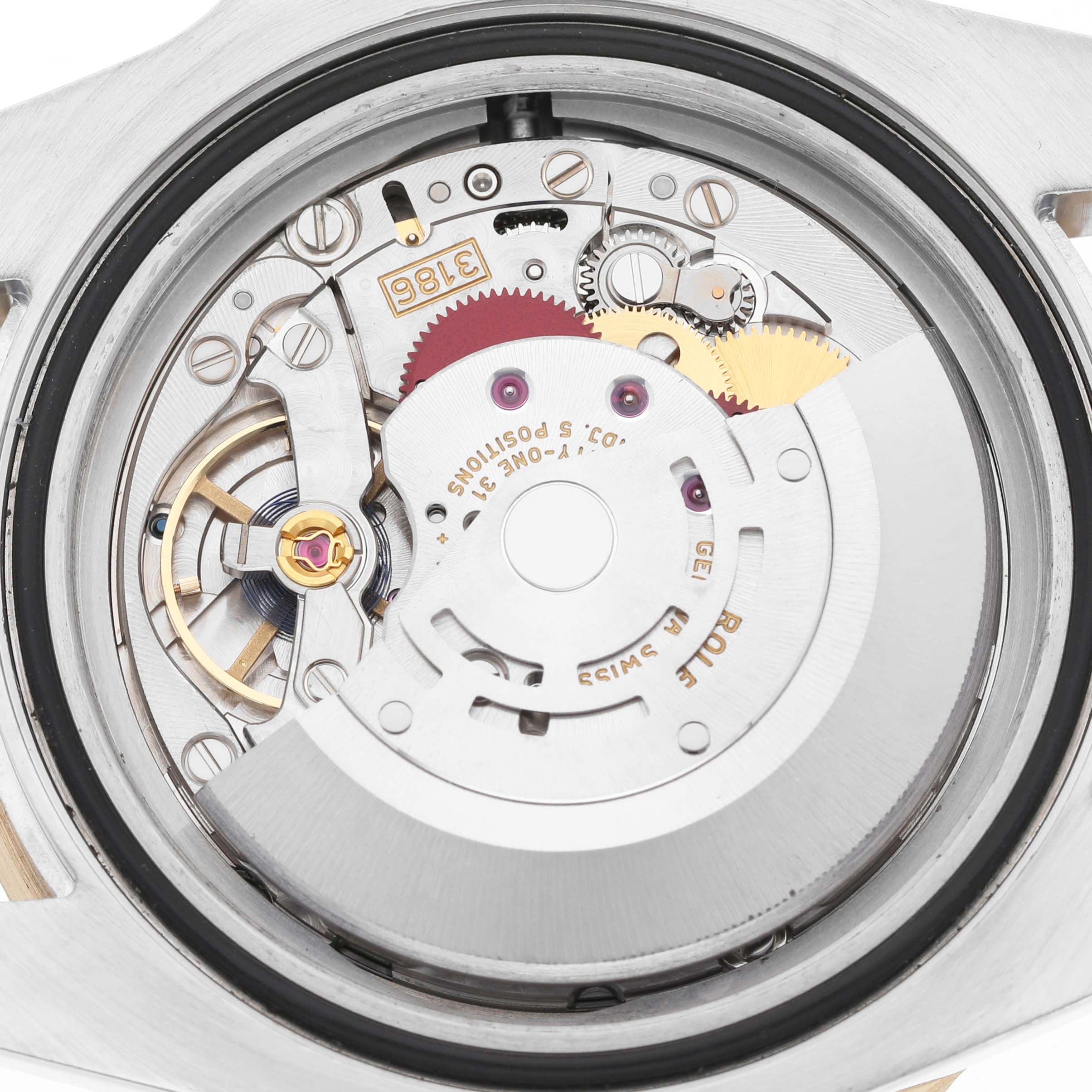 The image shows the movement of a Rolex GMT-Master M116713LN Men's Steel and Gold (two tone) Black Dial watch, viewed from the back, displaying gears and the rotor.