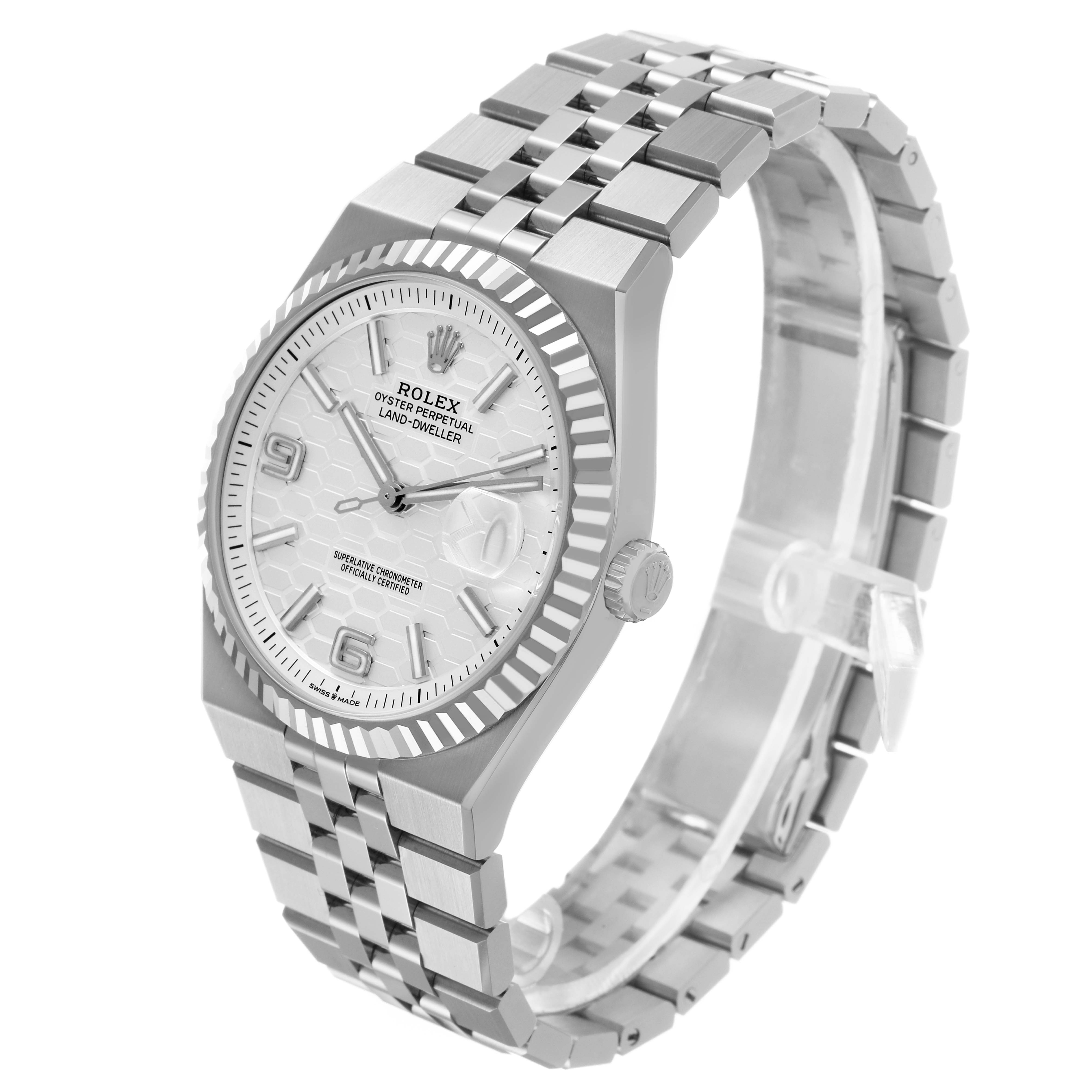The Rolex Land-Dweller watch is shown at a three-quarter angle highlighting the face, bezel, crown, and bracelet.