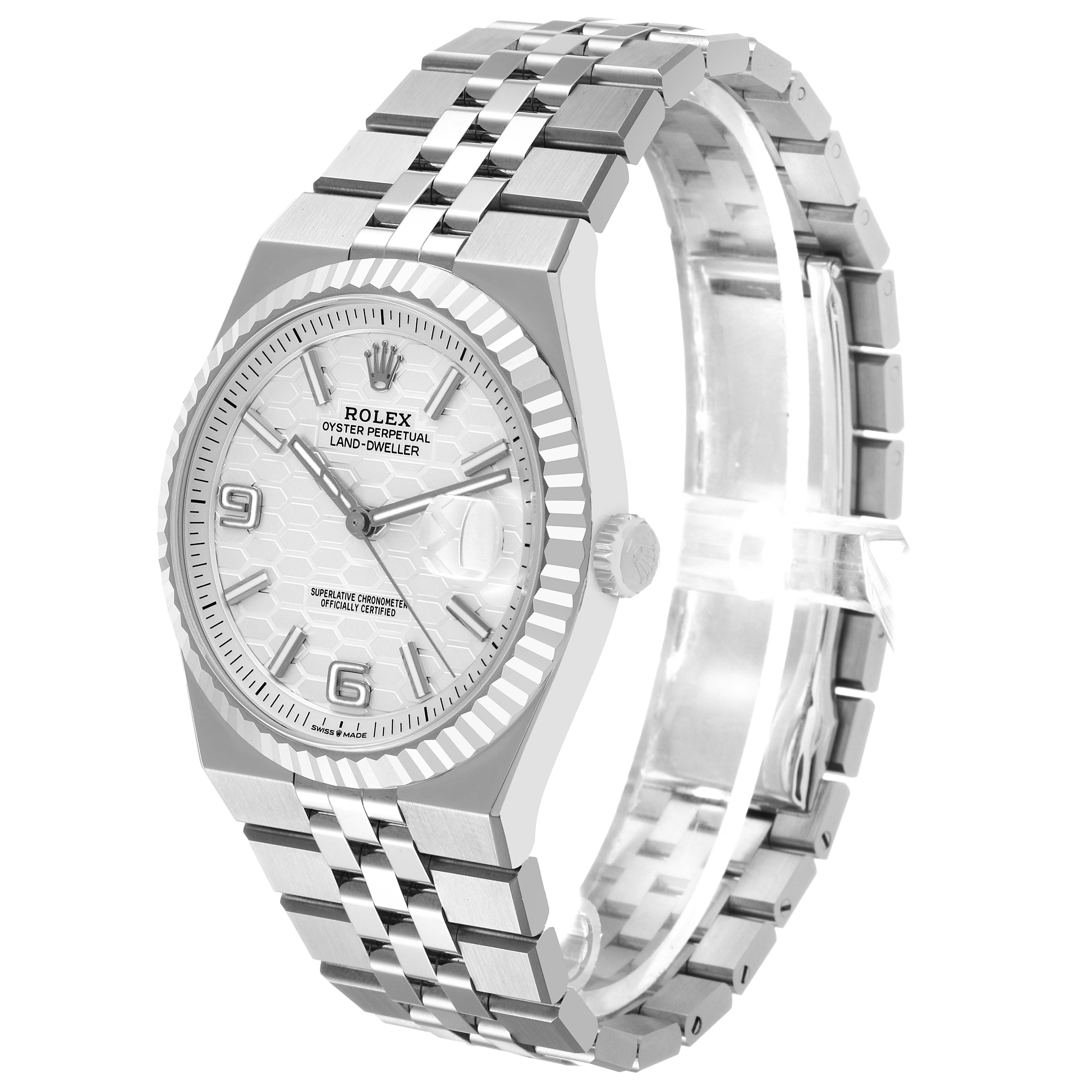 The Rolex Land-Dweller watch is shown at a three-quarter angle, highlighting the face, bezel, crown, and bracelet.