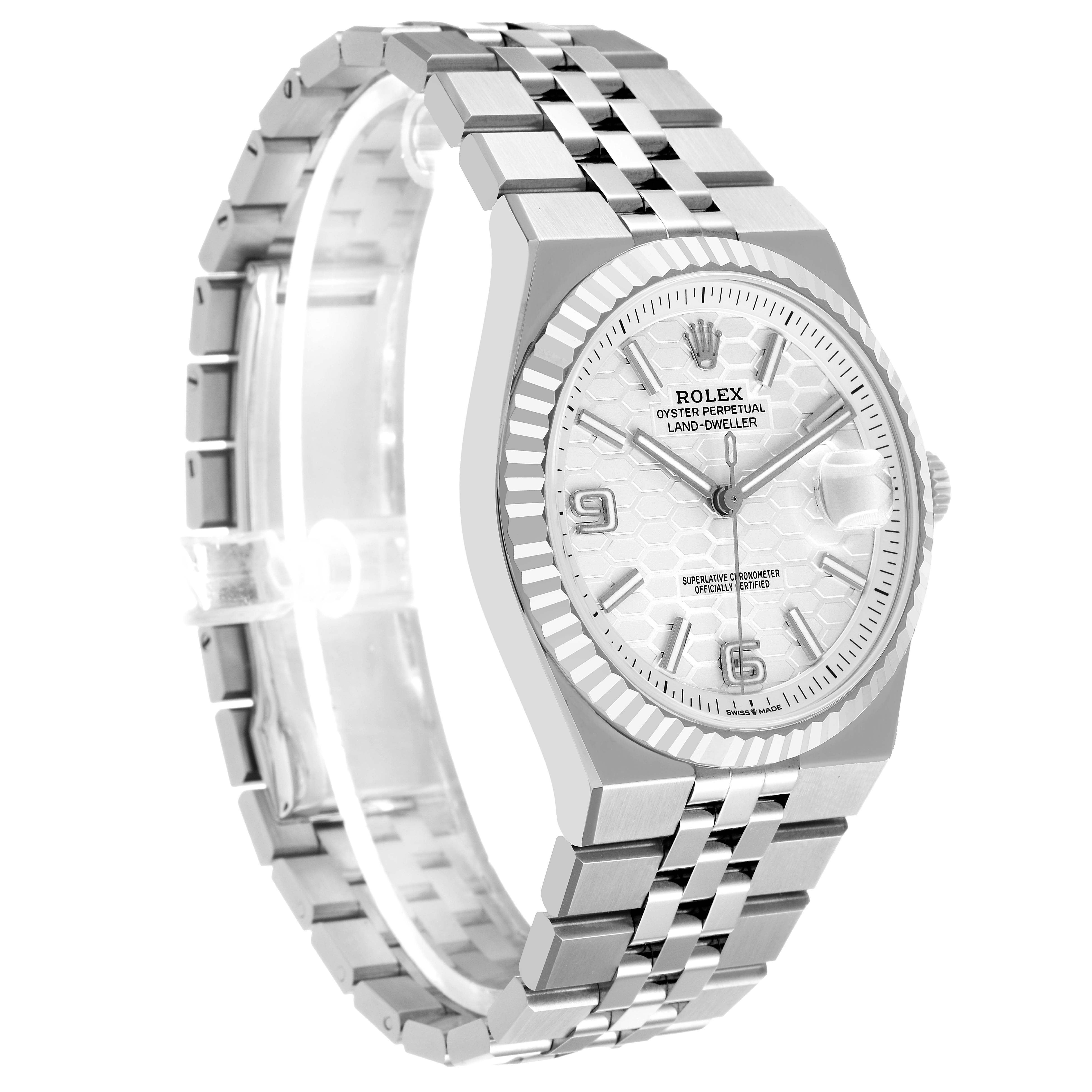 The Rolex Land-Dweller watch is shown at a three-quarter angle, highlighting the face, bezel, and bracelet.