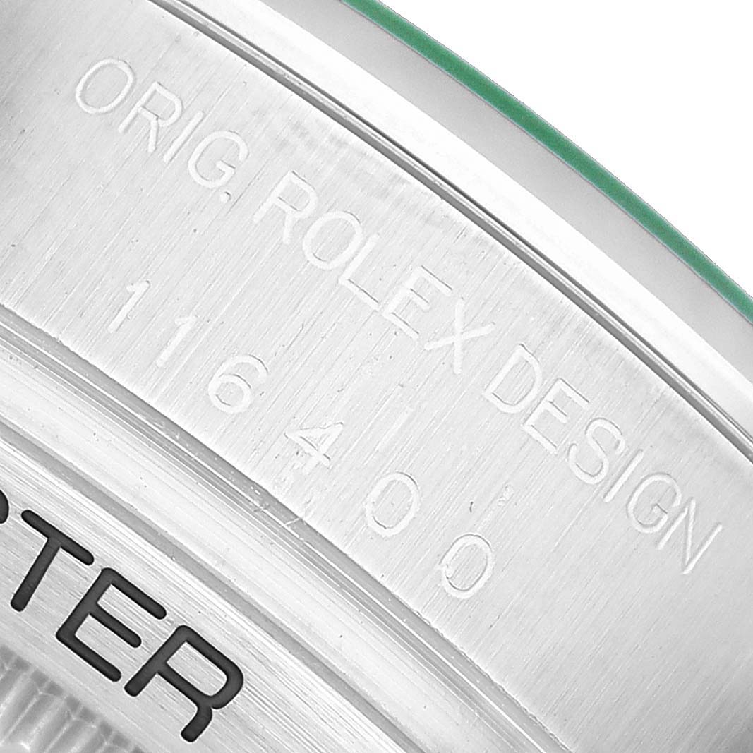 The image shows the side of a Rolex Milgauss M116400GV Men's Stainless Steel Blue Dial watch case with "ORG ROLEX DESIGN" and model number engraved.