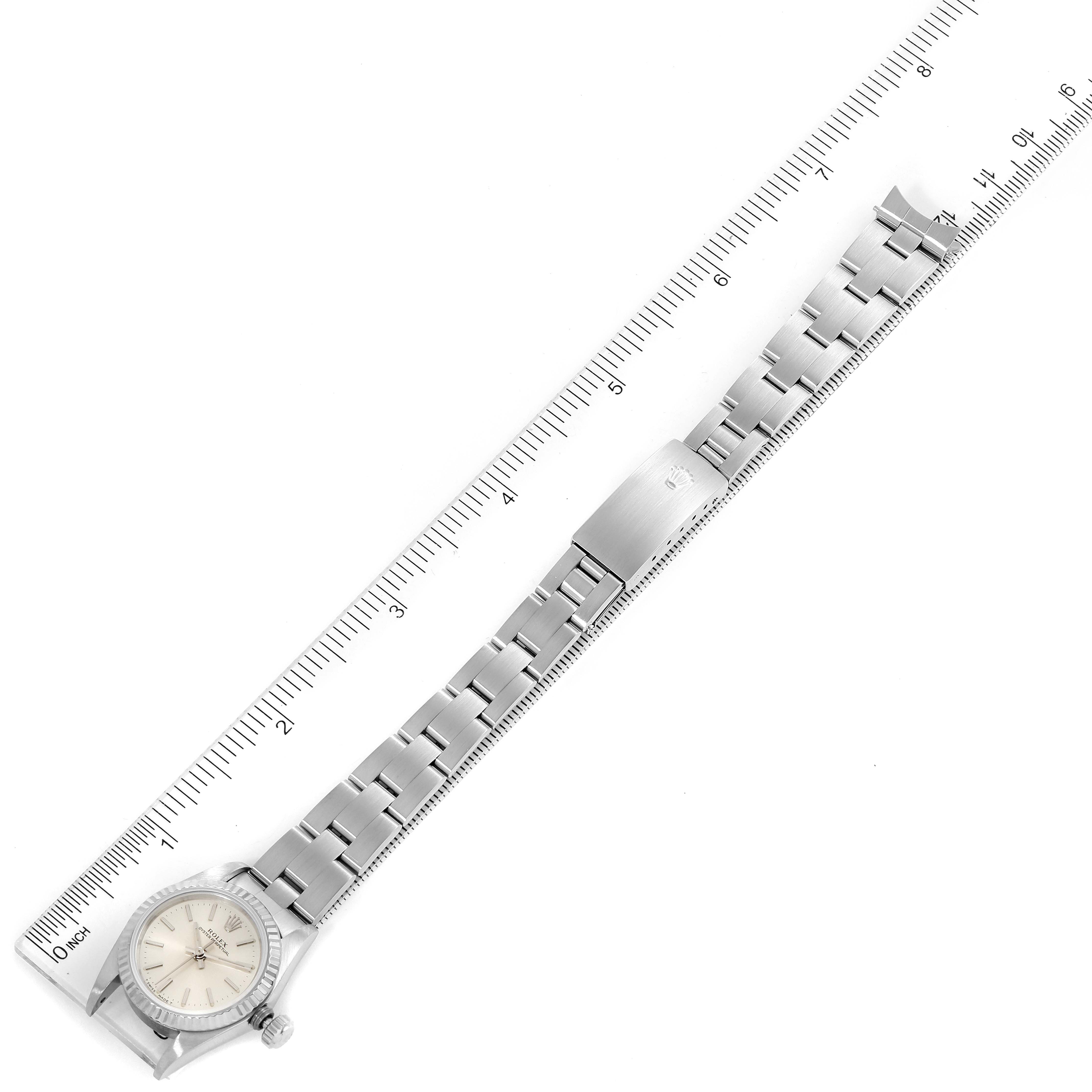 The image shows a Rolex Oyster Perpetual 67194 Women's Stainless Steel Silver Dial 67194 Women's Stainless Steel Silver Dial watch and its bracelet laid next to a ruler for measurement.