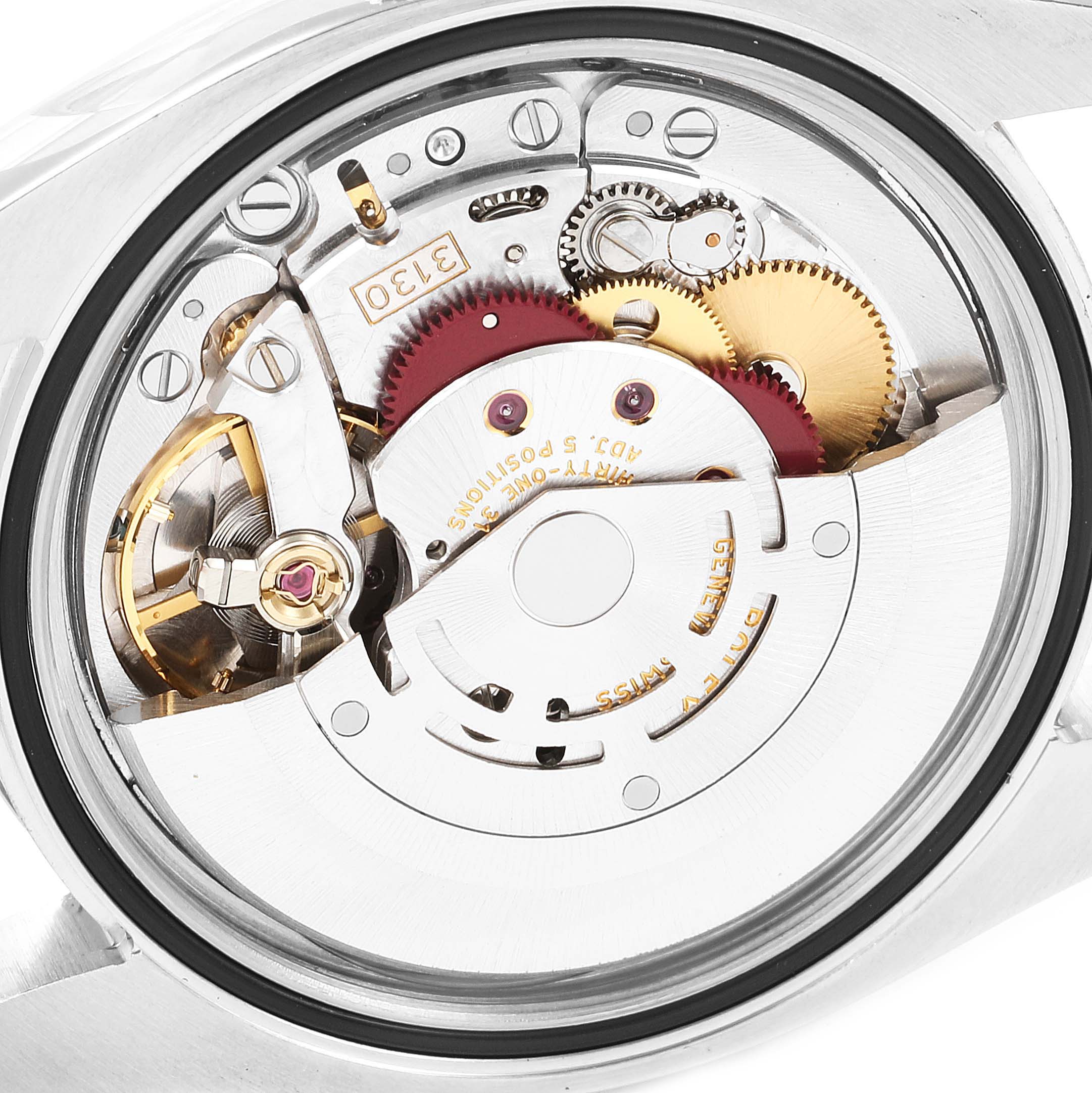 The image shows the back view of a Rolex Oyster Perpetual 116034 Men
s Stainless Steel Pink Dial 116034 Men
s Stainless Steel Pink Dial watch showcasing its intricate movement and internal mechanisms.