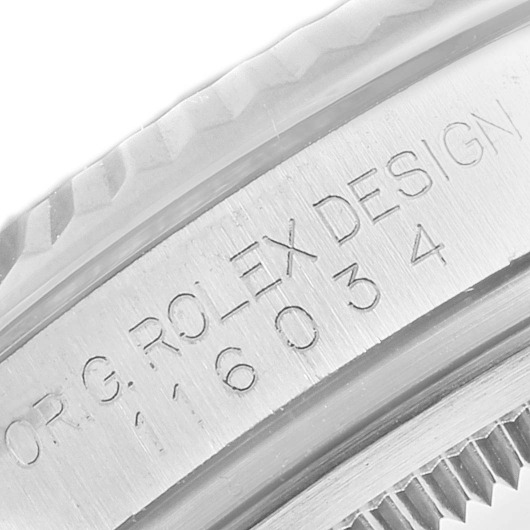 The image shows a close-up of the bezel and the engraving on the side of a Rolex Oyster Perpetual 116034 Men
s Stainless Steel Pink Dial 116034 Men
s Stainless Steel Pink Dial watch.