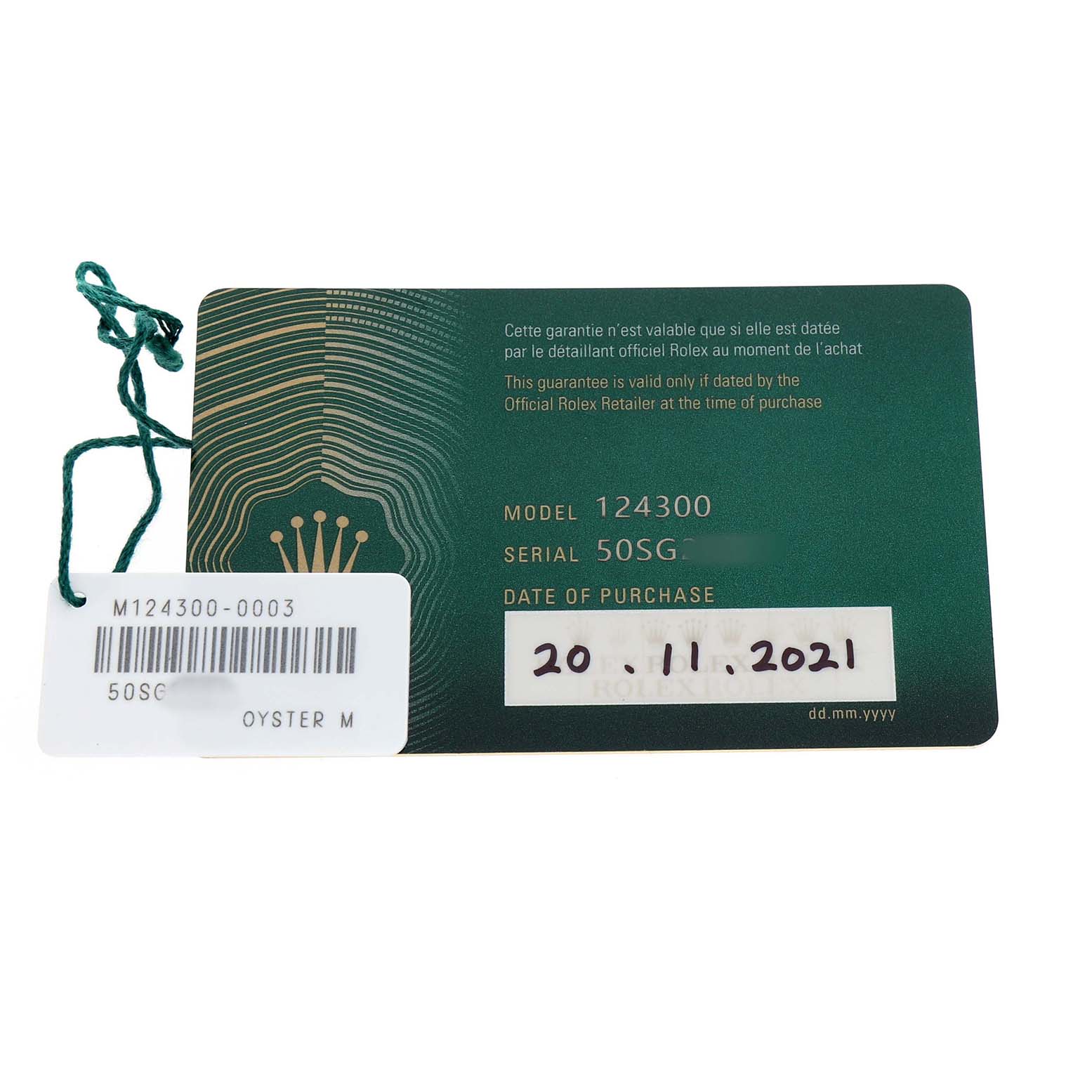 This image shows the warranty card and tag for a Rolex Oyster Perpetual 124300 Men's Stainless Steel Blue Dial model, displaying model, serial number, and purchase date.