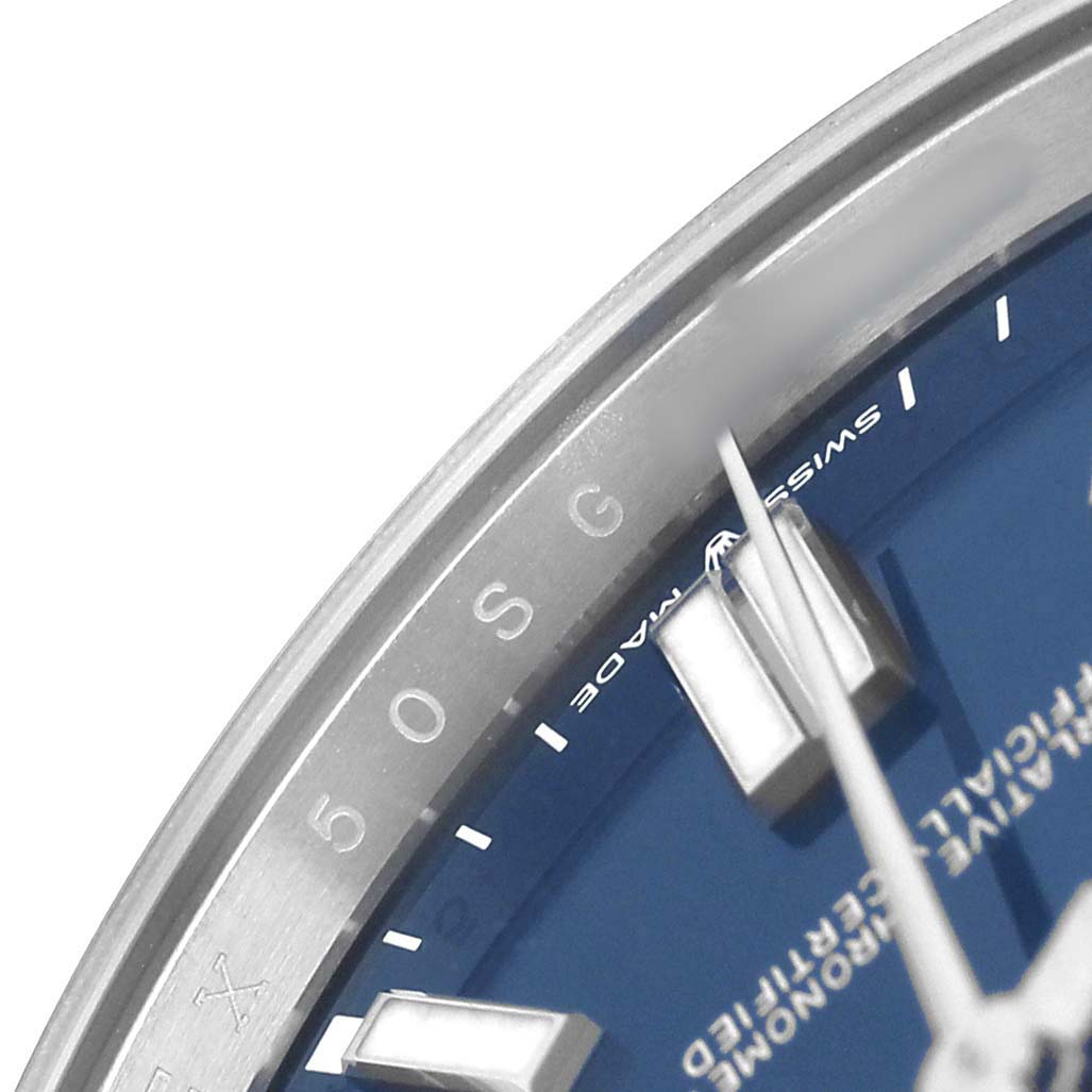 The image shows a close-up of the dial edge and minute hand of the Rolex Oyster Perpetual 124300 Men's Stainless Steel Blue Dial watch, highlighting part of the bezel and markers.