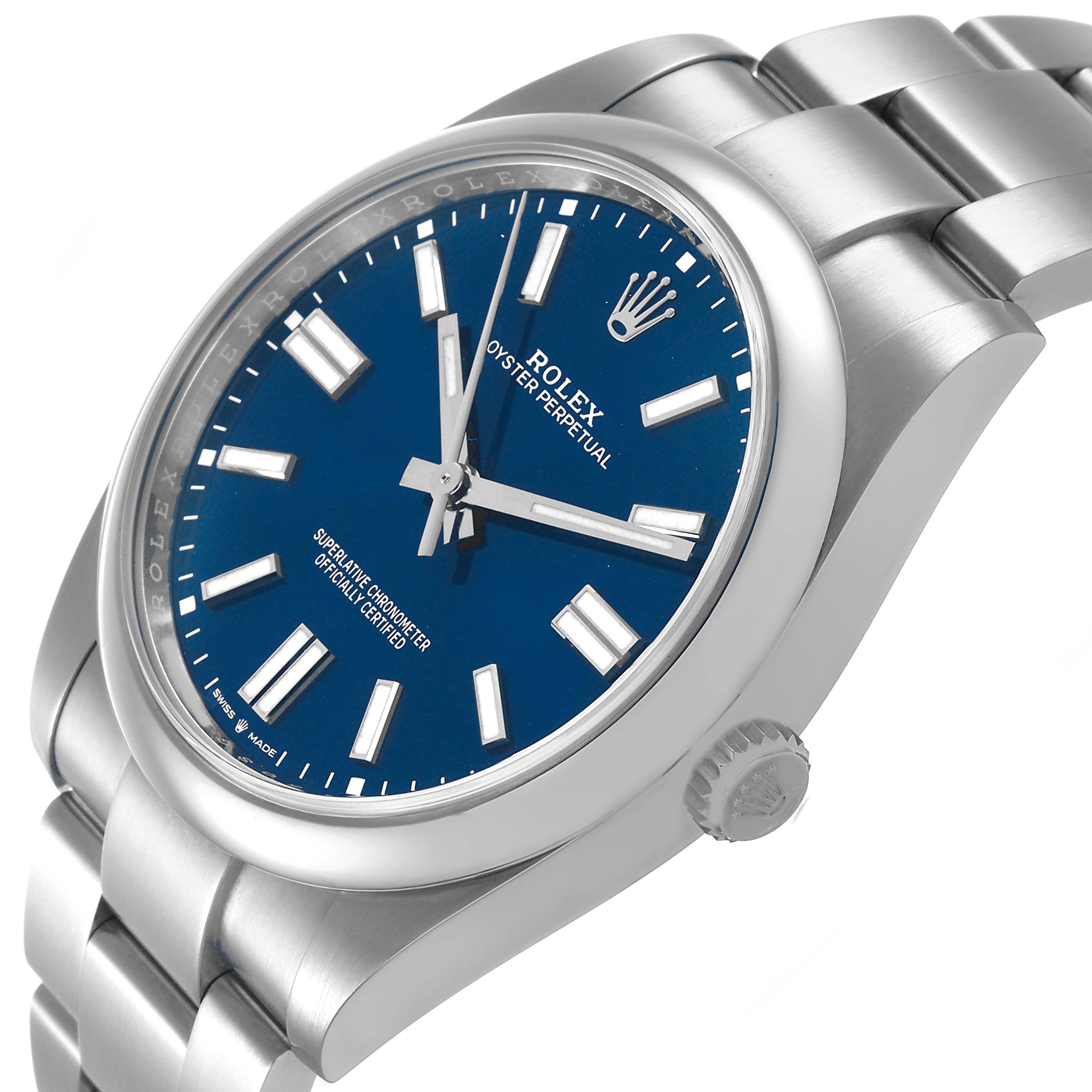 The Rolex Oyster Perpetual 124300 Men's Stainless Steel Blue Dial watch is shown at an angle highlighting its blue dial, crown, and stainless steel bracelet.