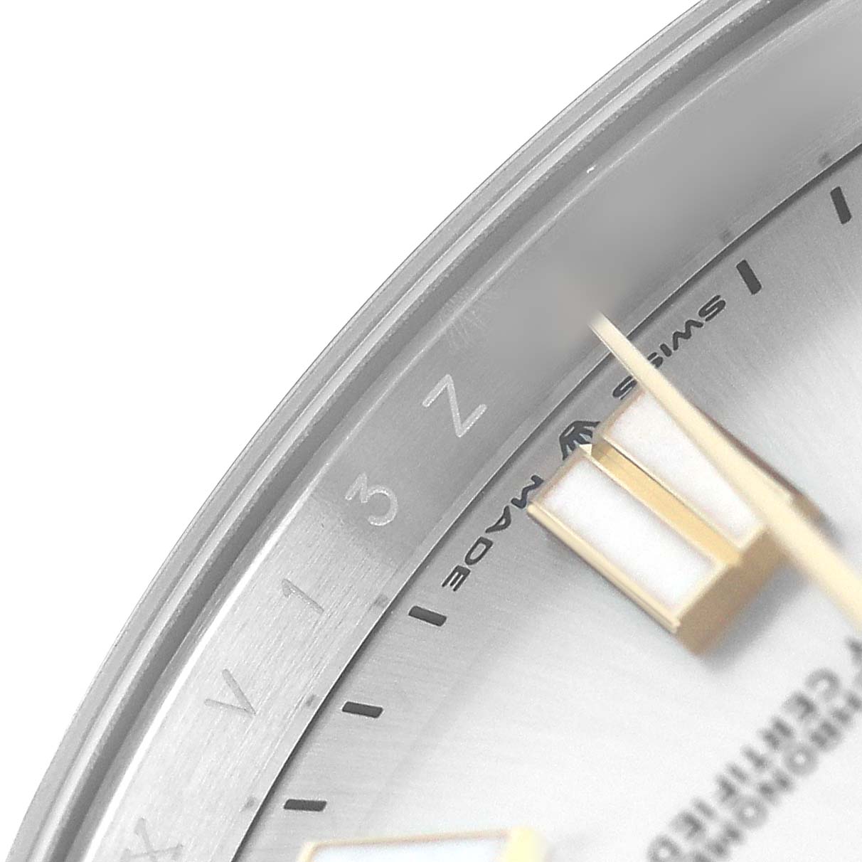 The image shows a close-up of the Rolex Oyster Perpetual 124300 Men's Stainless Steel Silver Dial watch's dial, including part of the bezel and hour markers.
