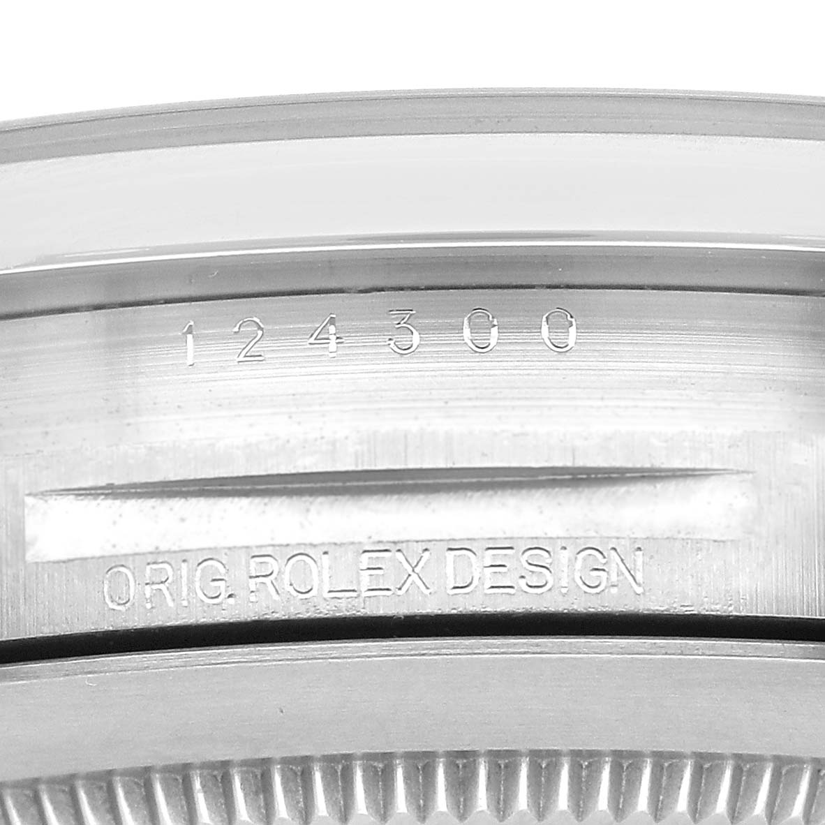 The image shows a close-up of the model number and "Orig. Rolex Design" engraving on the case of a Rolex Oyster Perpetual 124300 Men's Stainless Steel Silver Dial watch.