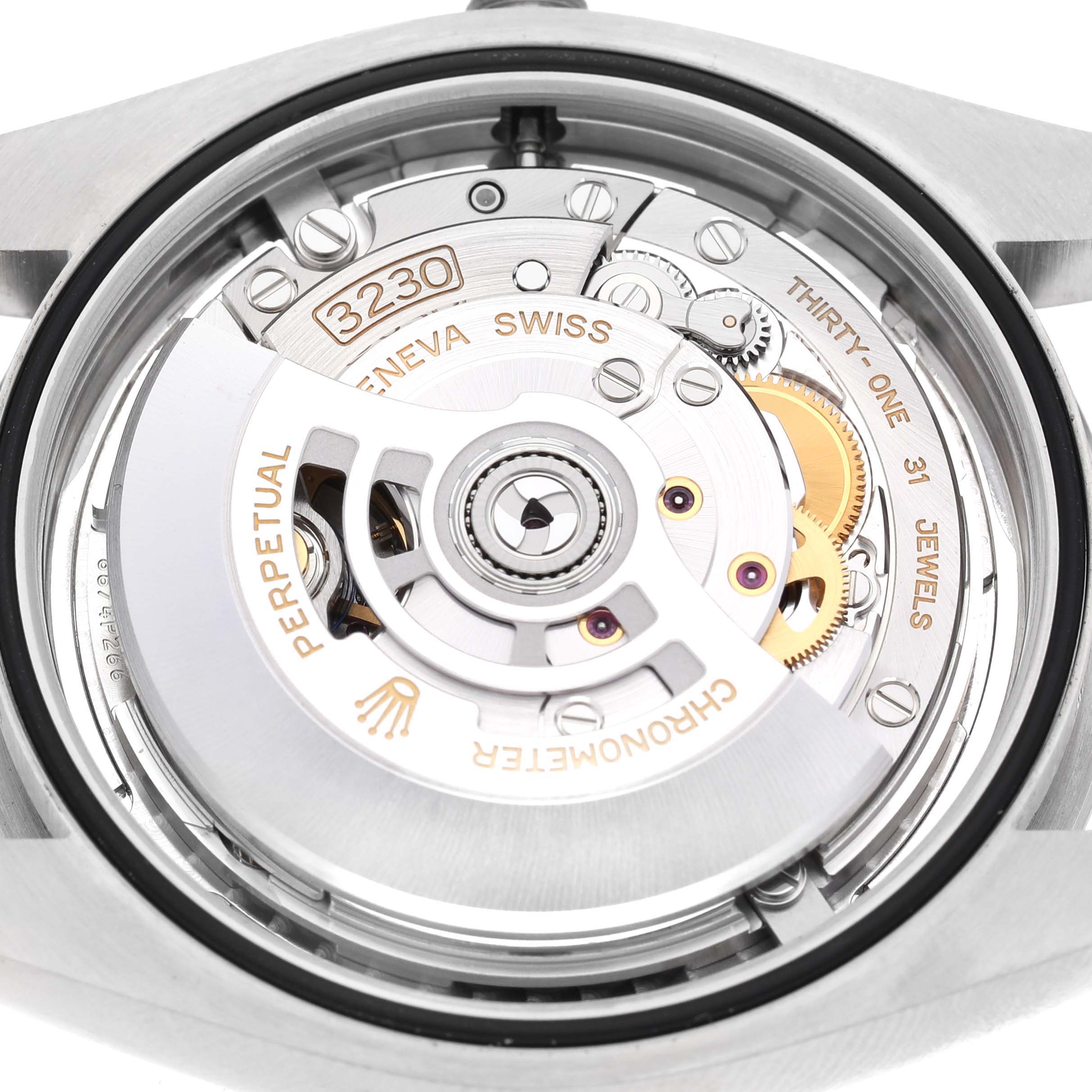 The image shows the movement of a Rolex Oyster Perpetual 124300 Men's Stainless Steel Silver Dial watch from a rear angle, highlighting its mechanical components.