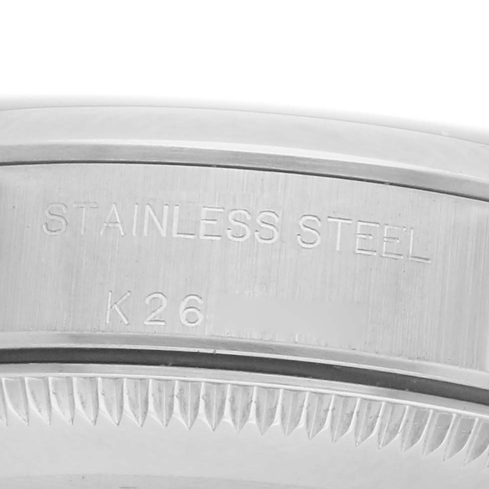 The image shows a close-up of the stainless steel case back of a Rolex Oyster Perpetual 76080 Women
s Stainless Steel Black Dial 76080 Women
s Stainless Steel Black Dial watch.