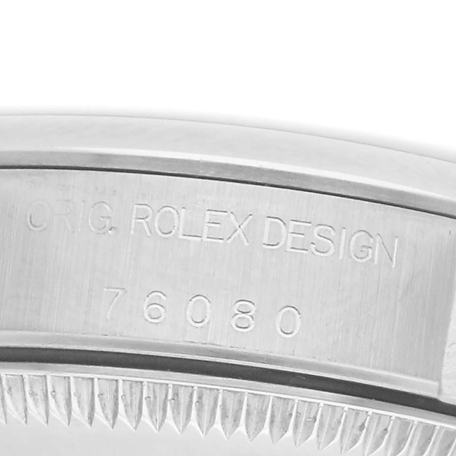 The image shows the side view of the Rolex Oyster Perpetual 76080 Women
s Stainless Steel Black Dial 76080 Women
s Stainless Steel Black Dial
s case, highlighting "ORIG. ROLEX DESIGN" and the model number 76080.