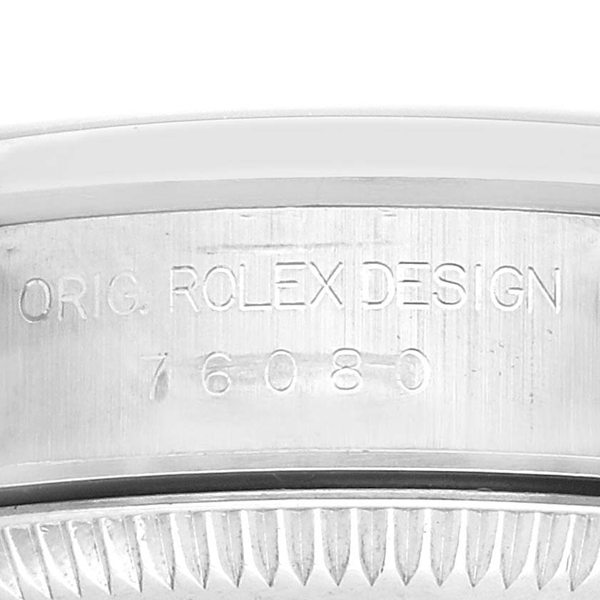 The image shows a close-up of the side detail on a Rolex Oyster Perpetual 76080 Women
s Stainless Steel Black Dial 76080 Women
s Stainless Steel Black Dial, highlighting the engraved model number.
