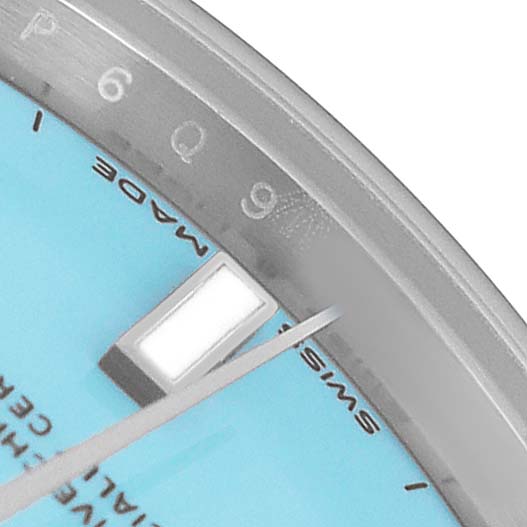 The image shows a close-up of the dial and bezel of a Rolex Oyster Perpetual 277200 Women's Stainless Steel Blue Dial watch, focusing on the hour markers and minute hand.