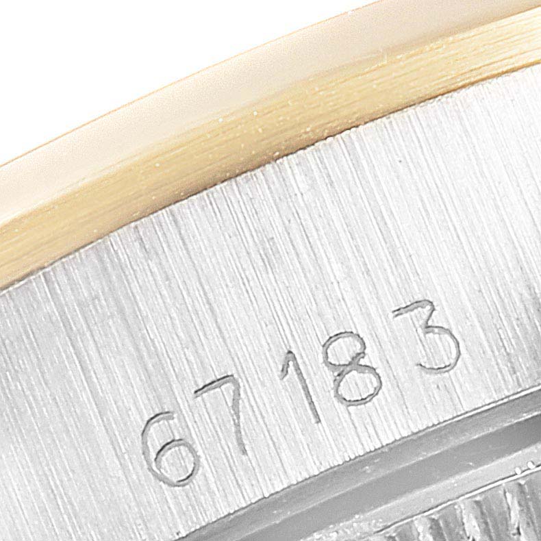 This close-up image shows the serial number engraved on the case of a Rolex Oyster Perpetual 67183 Women's Steel and Gold (two tone) Champagne Dial 67183 Women's Steel and Gold (two tone) Champagne Dial watch.