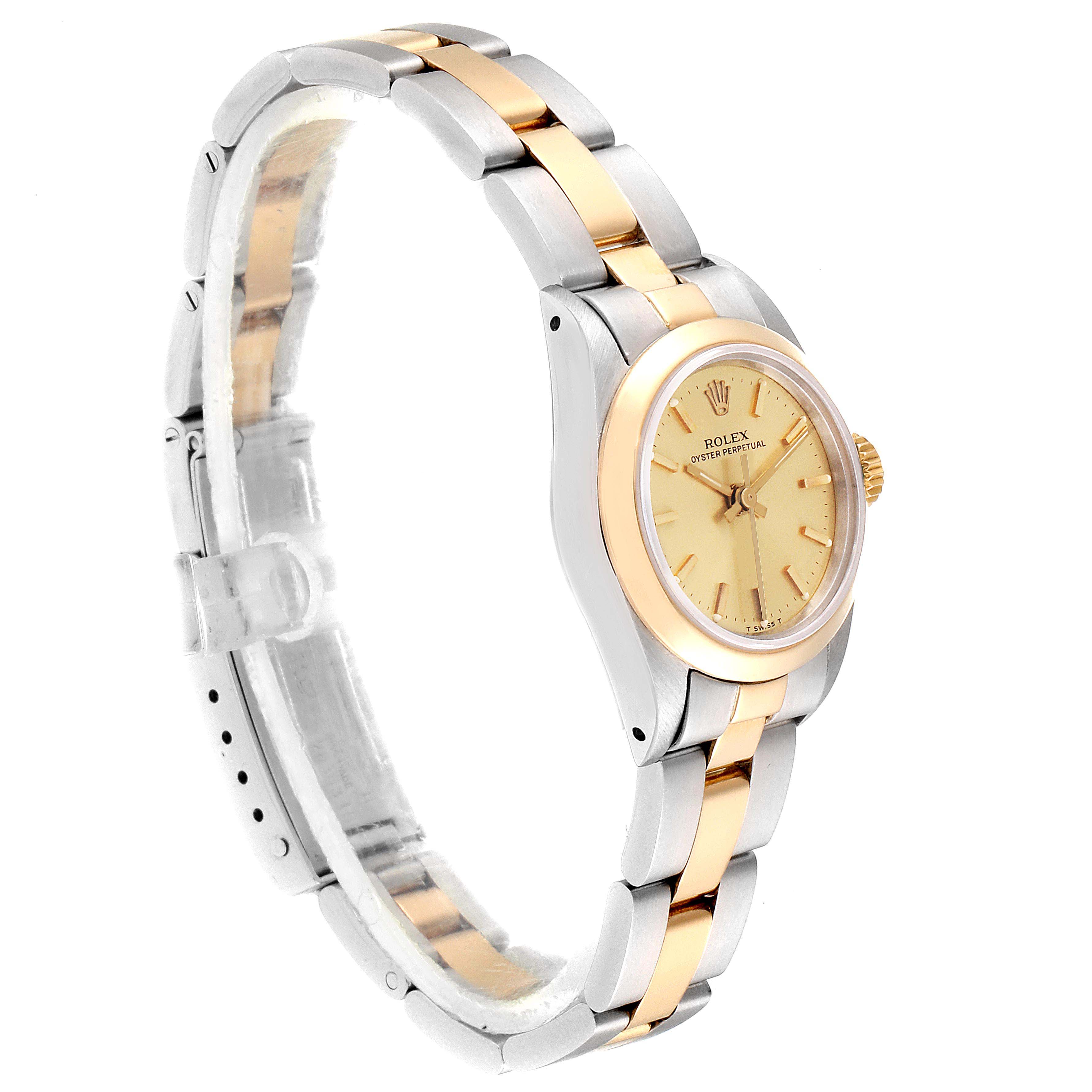 The Rolex Oyster Perpetual 67183 Women's Steel and Gold (two tone) Champagne Dial 67183 Women's Steel and Gold (two tone) Champagne Dial watch is shown from an angled side view, highlighting its two-tone bracelet and bezel.