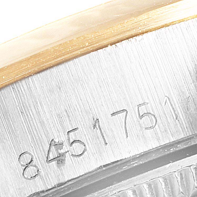 This image shows a close-up of the serial number on the case of a Rolex Oyster Perpetual 67183 Women's Steel and Gold (two tone) Champagne Dial 67183 Women's Steel and Gold (two tone) Champagne Dial watch.