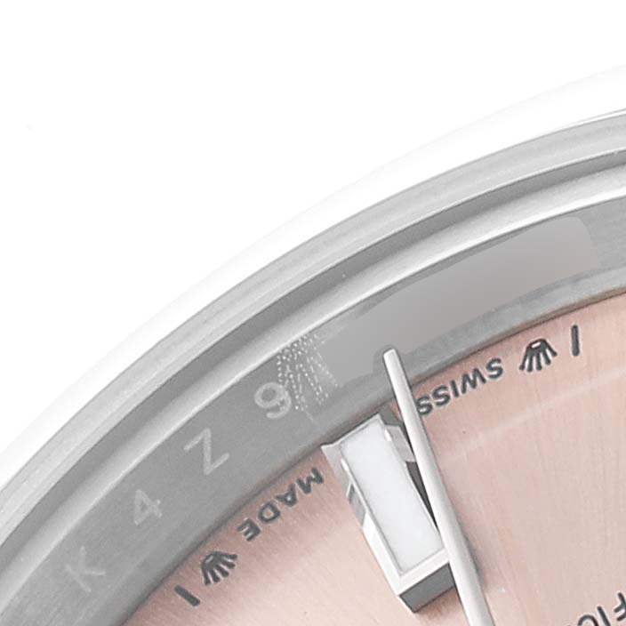 This close-up image shows part of the dial, hands, and markers of a Rolex Oyster Perpetual 276200 Women
s Stainless Steel Pink Dial 276200 Women
s Stainless Steel Pink Dial watch.