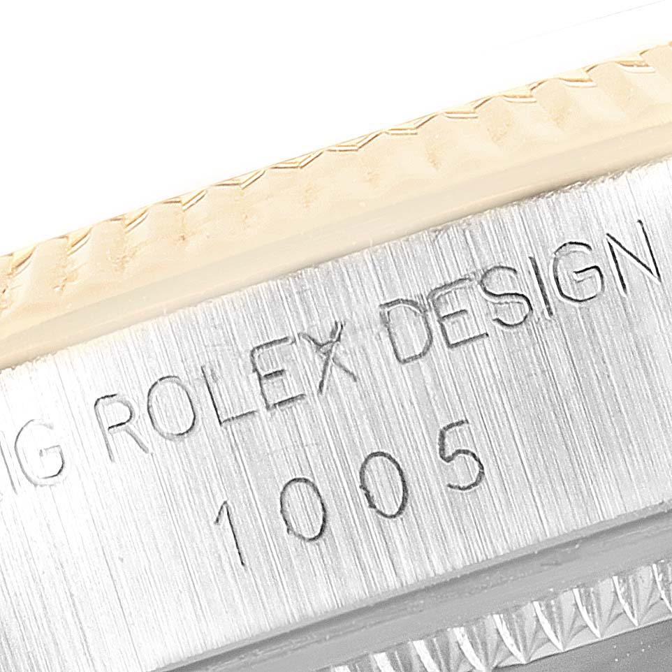 This image shows a close-up of the bezel and engraved text on an Oyster Perpetual model by Rolex.