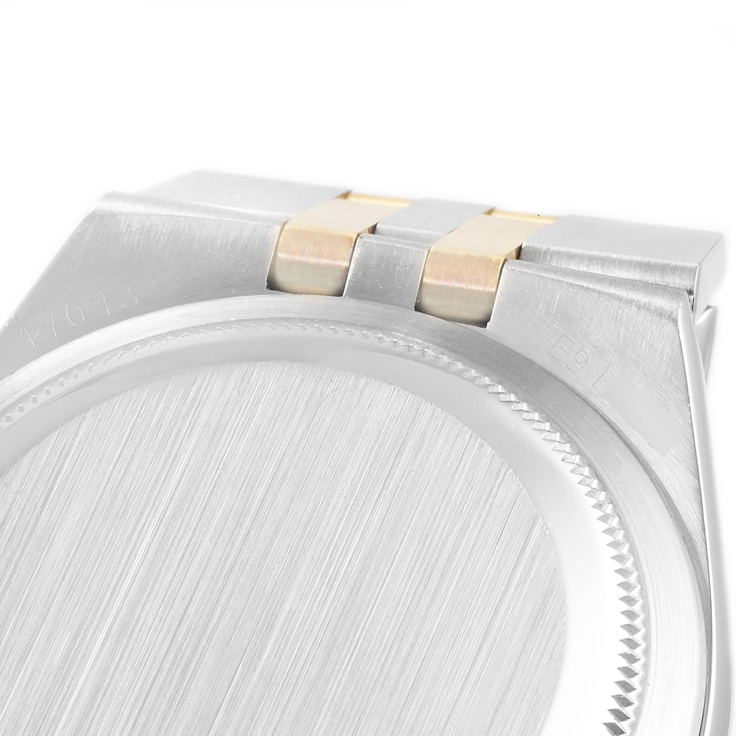 The image shows the back case and part of the bracelet links of a Rolex Oysterquartz 17013 Men's Steel and Gold (two tone) Champagne Dial 17013 Men's Steel and Gold (two tone) Champagne Dial watch.