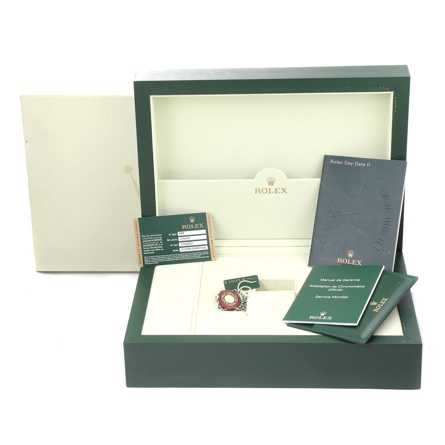 The image shows an open box for the Rolex President 218206 Men's Platinum Blue Dial 218206 Men's Platinum Blue Dial model, including a manual, warranty card, and other accessories.