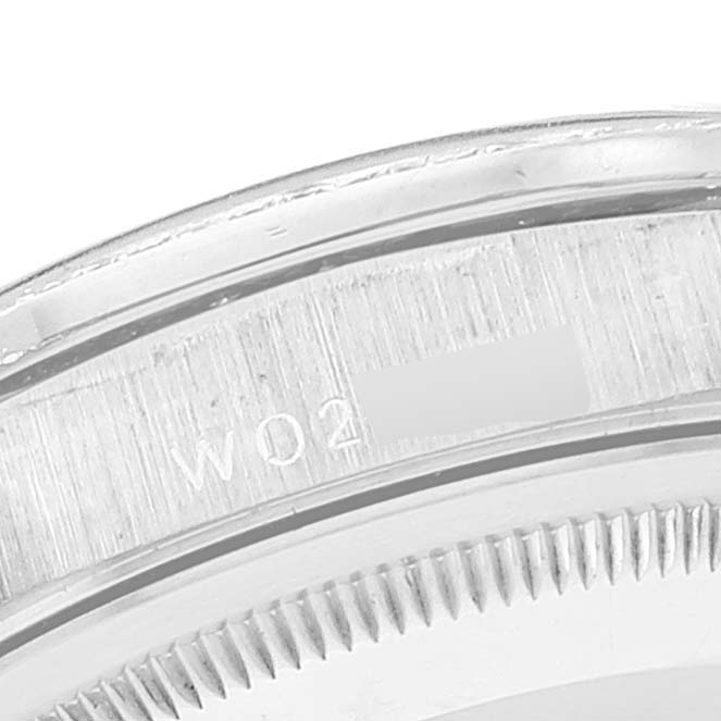 This close-up image shows the edge and serial number engraving on the back case of a Rolex President 18346 Men's Platinum Silver Dial 18346 Men's Platinum Silver Dial model watch.