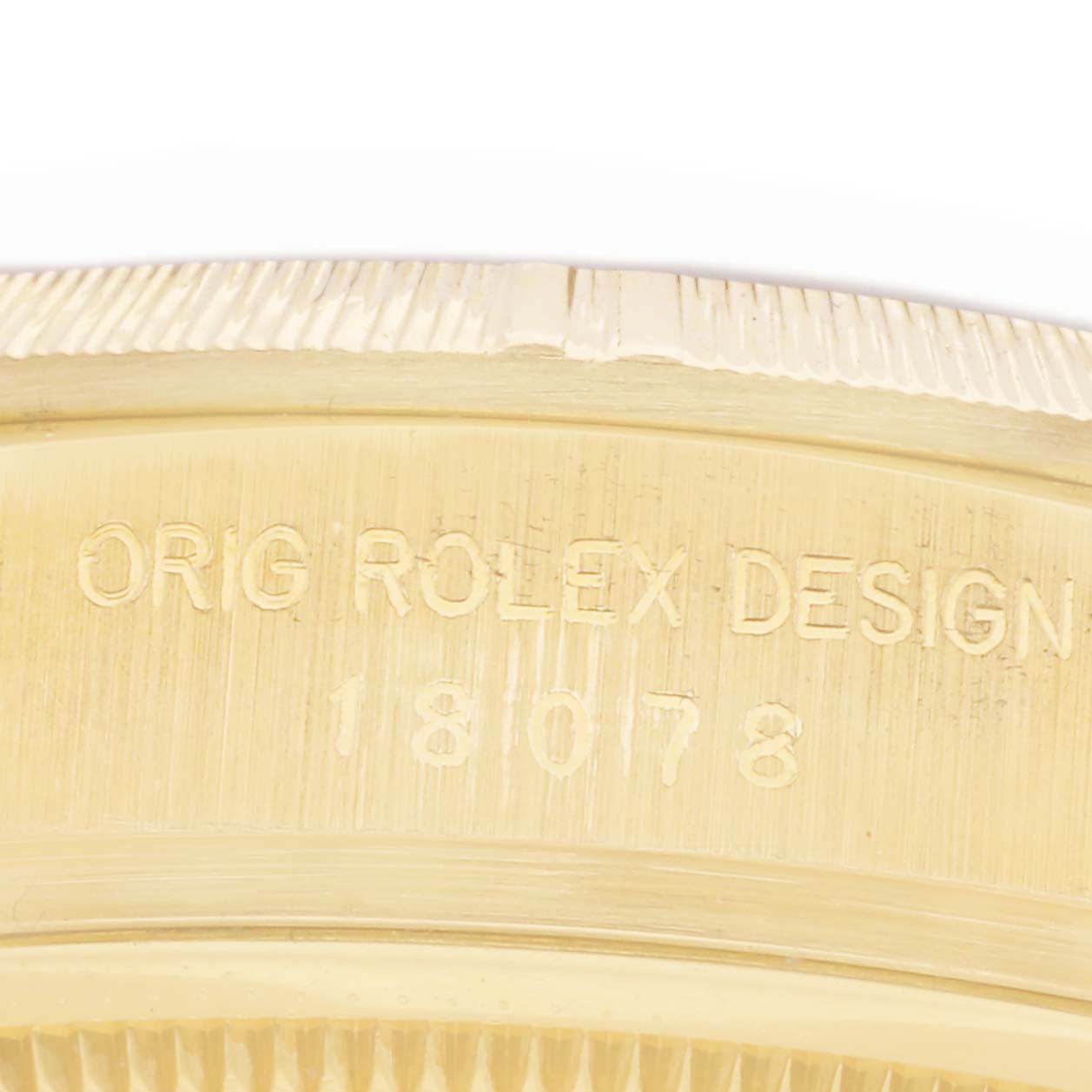 The image shows a close-up of the bezel and engraved details of a Rolex President 18078 Men
s Yellow Gold Silver Dial 18078 Men
s Yellow Gold Silver Dial model.