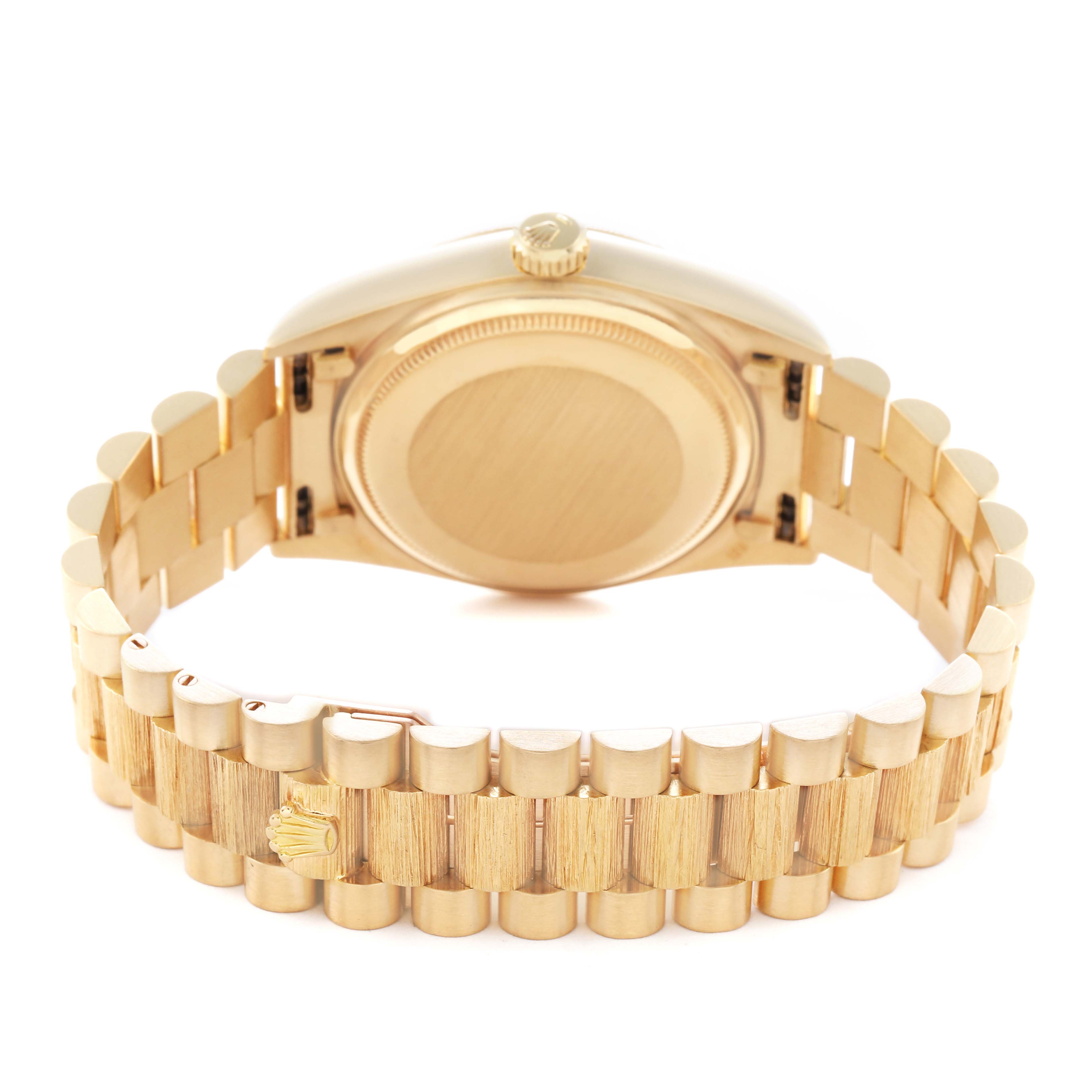 The Rolex President 18078 Men
s Yellow Gold Silver Dial 18078 Men
s Yellow Gold Silver Dial model is shown from the rear, highlighting its gold case back and bracelet.