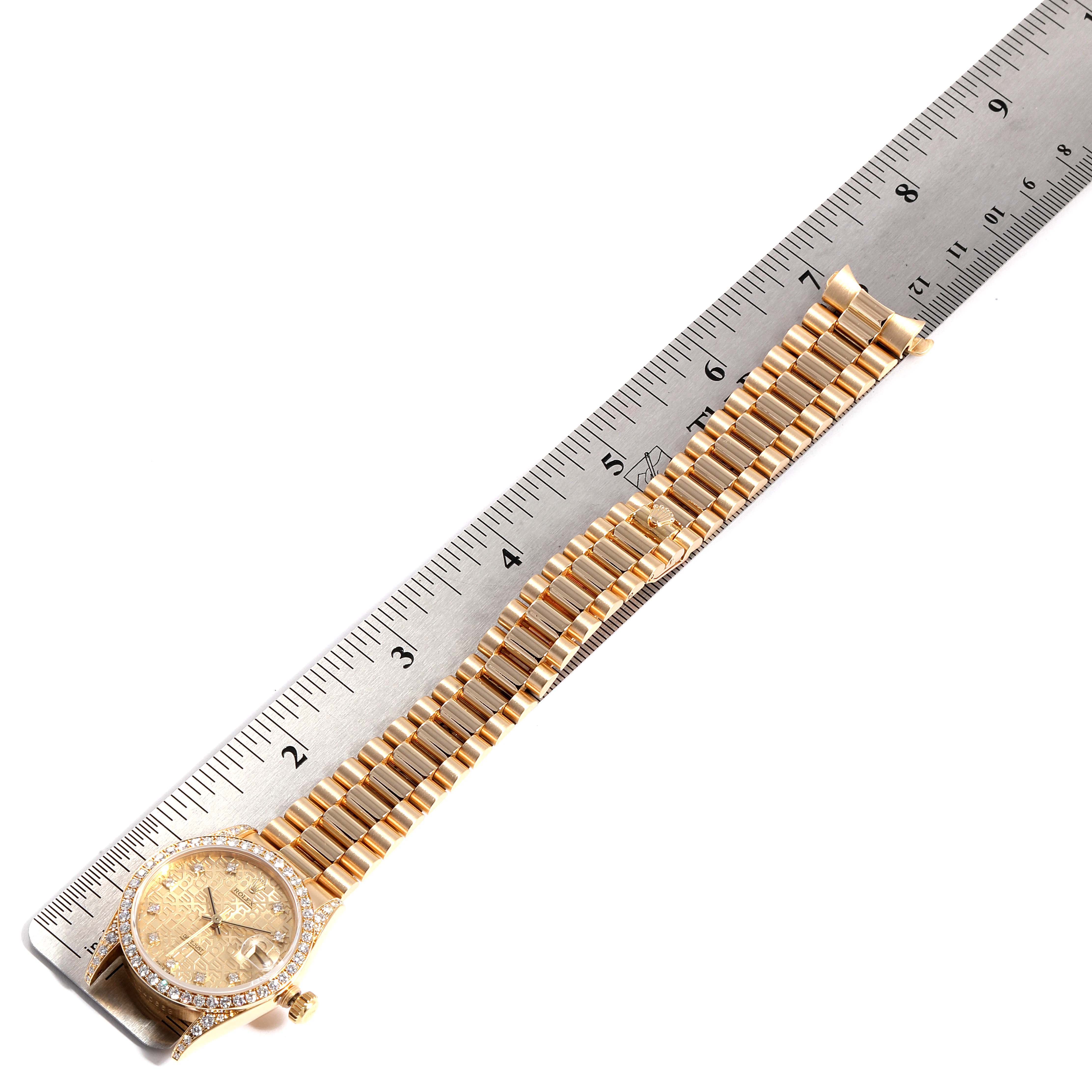 The Rolex President 68158 Women's Yellow Gold Champagne Dial 68158 Women's Yellow Gold Champagne Dial model watch is shown from a top-down angle, alongside a ruler.