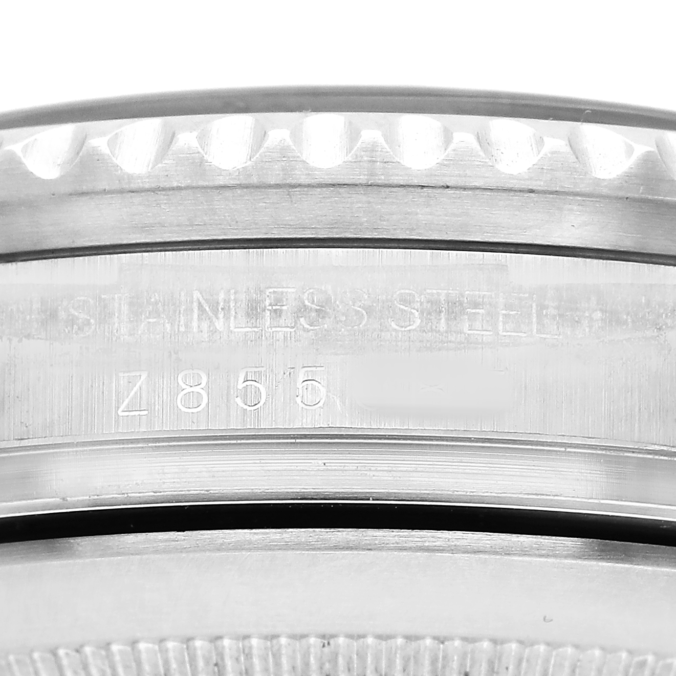 The image shows a close-up of the stainless steel case and bezel edge on a Rolex Sea-Dweller 16600 Men's Stainless Steel Black Dial watch with visible markings and engraving.