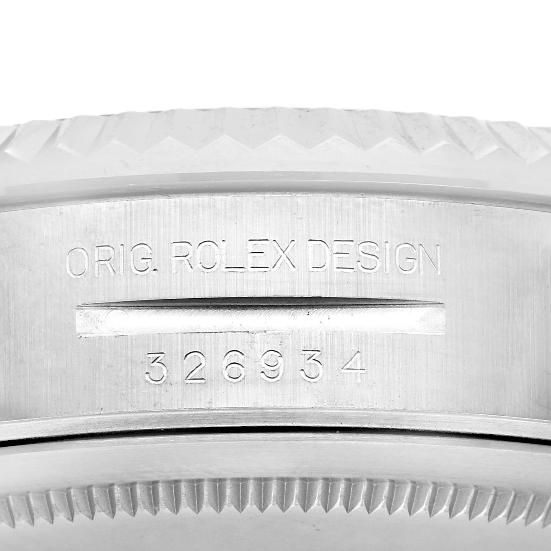 The image shows a close-up of the side of a Rolex Sky-Dweller 326934 Men
s Stainless Steel Blue Dial 326934 Men
s Stainless Steel Blue Dial watch, highlighting the model number "326934" and "ORIG. ROLEX DESIGN" engraving.